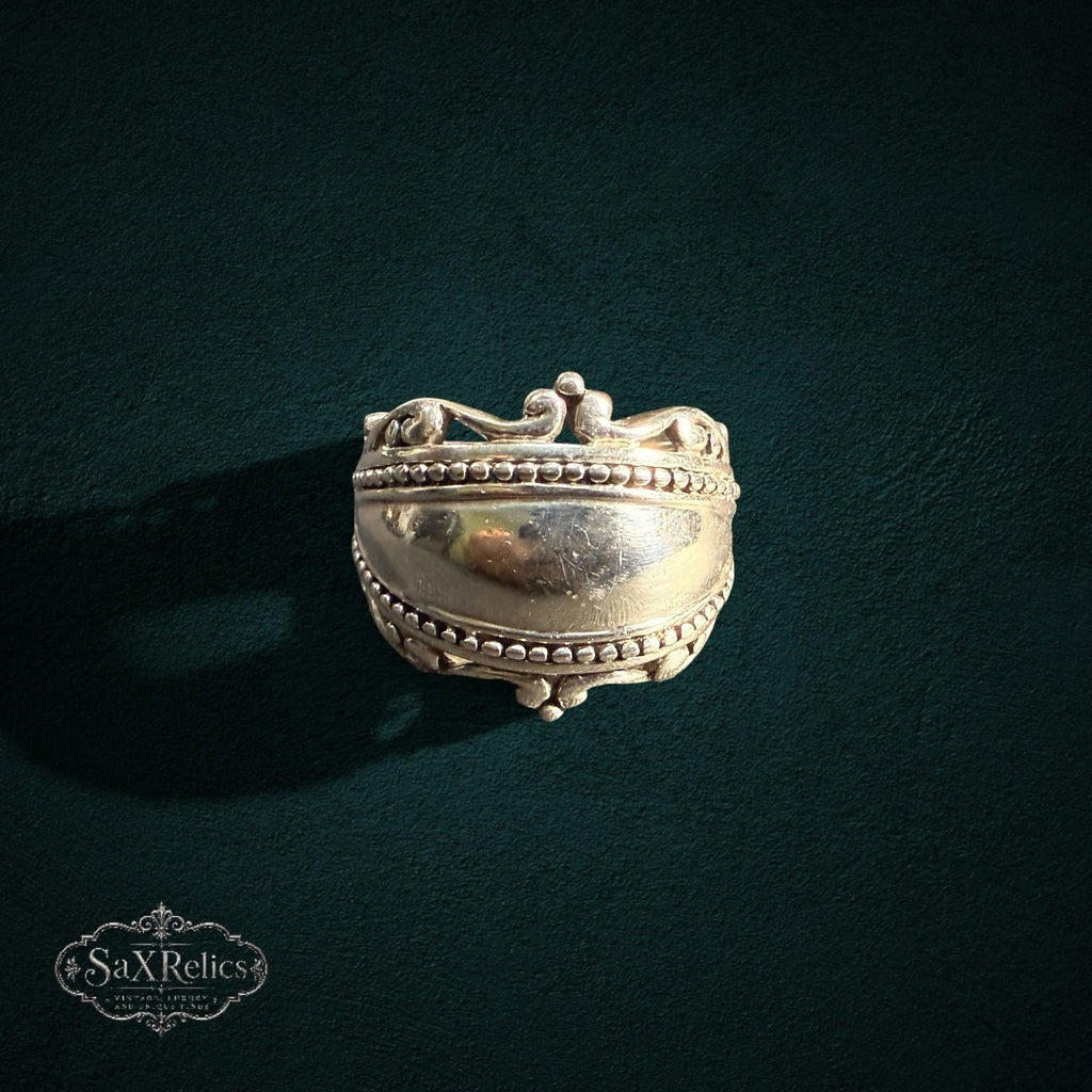 My Store SAXRelics sterling silver statement ring featuring a polished dome, beaded borders, and ornate scrollwork.