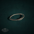 My Store delicate 925 sterling silver band ring featuring a row of shimmering clear stones on a dark green background.