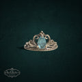 My Store sterling silver tiara ring featuring a pear-cut light blue gemstone with intricate filigree crown detailing.