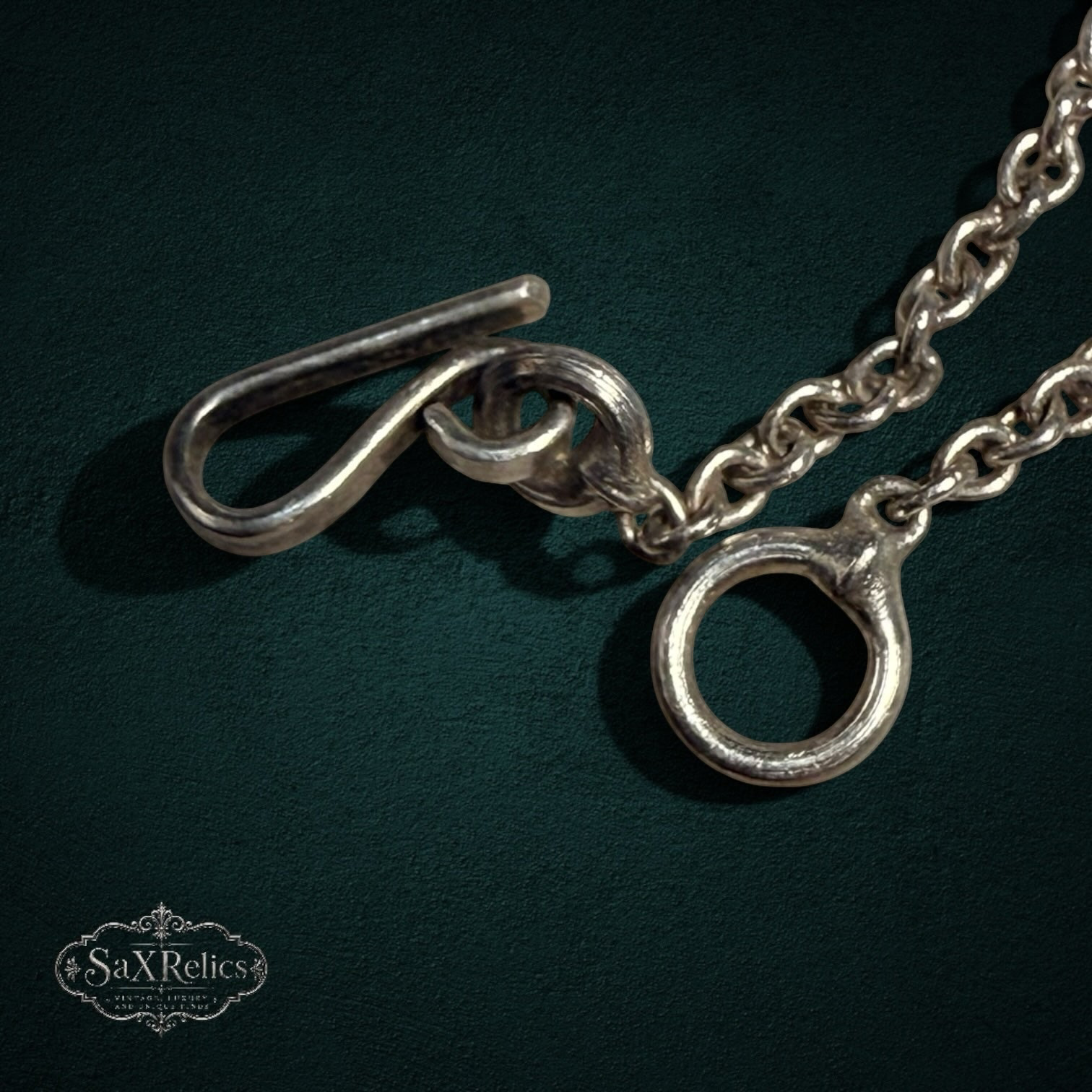 My Store sterling silver toggle clasp on an ornate filigree statement necklace with a polished metal finish.