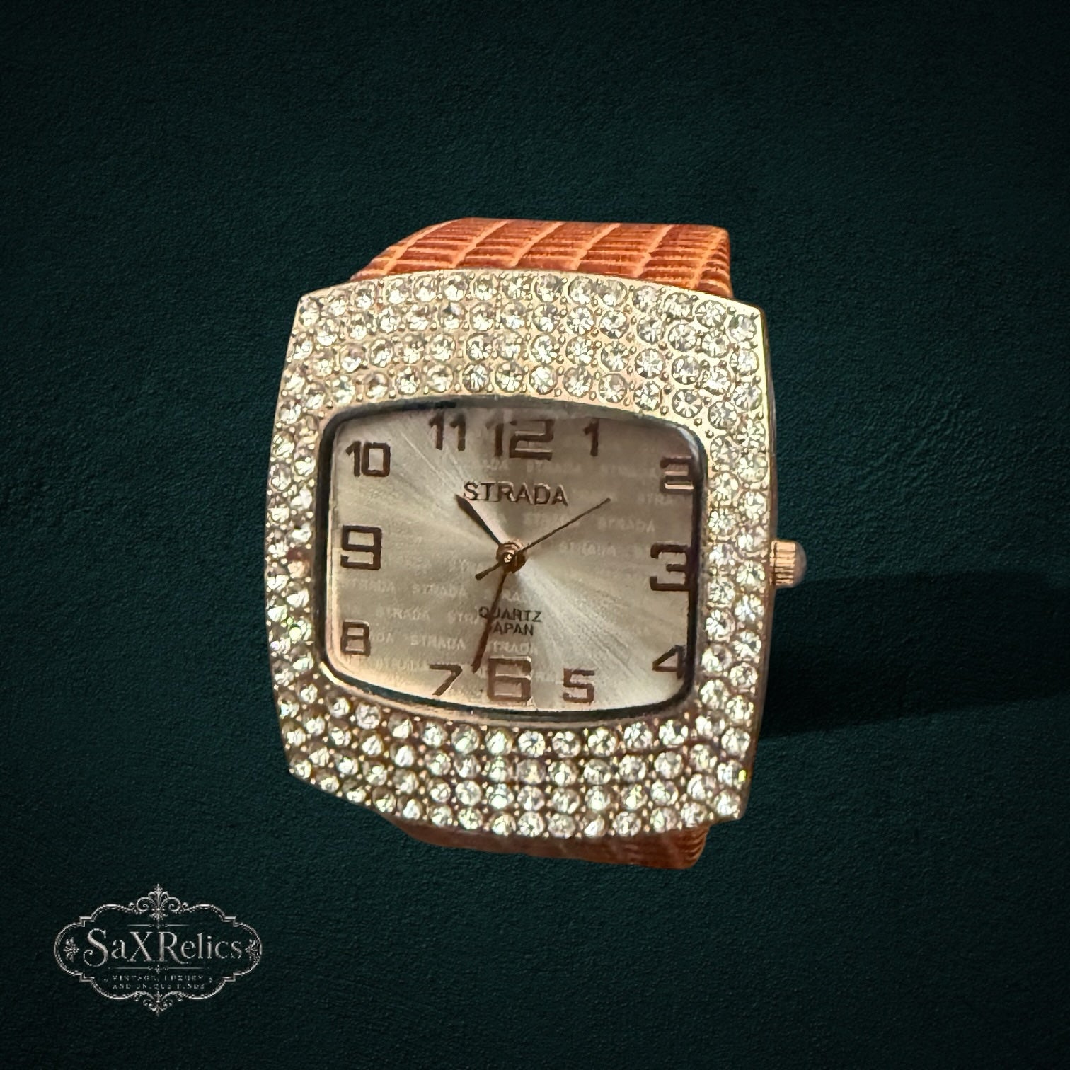 My Store Strada square wristwatch with a crystal-encrusted bezel, silver dial, and textured tan strap.