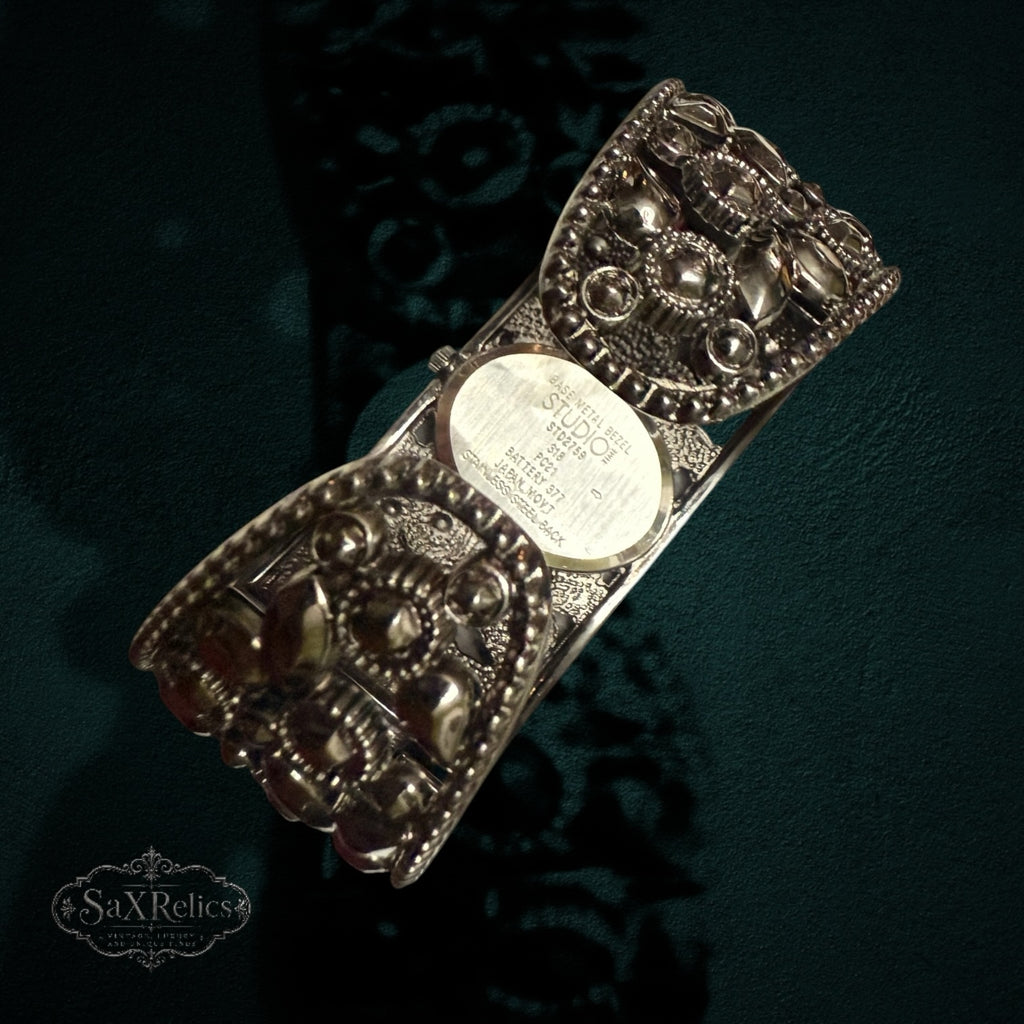 My Store STUDIO cuff watch back view showing stainless steel case and ornate gunmetal open-work metal band