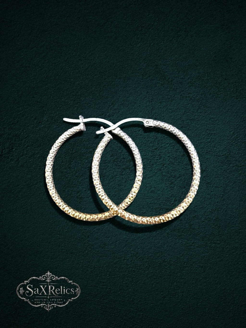 My Store SAXRelics textured hoop earrings with a diamond-cut finish and geometric pattern on a dark green background.