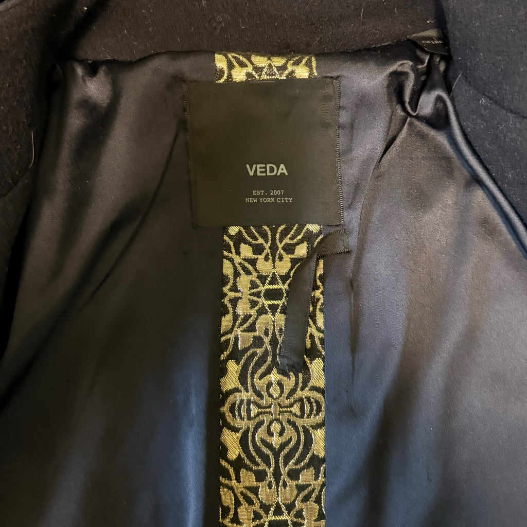 My Store VEDA jacket interior featuring black lining and intricate gold-toned brocade detail on the brand label