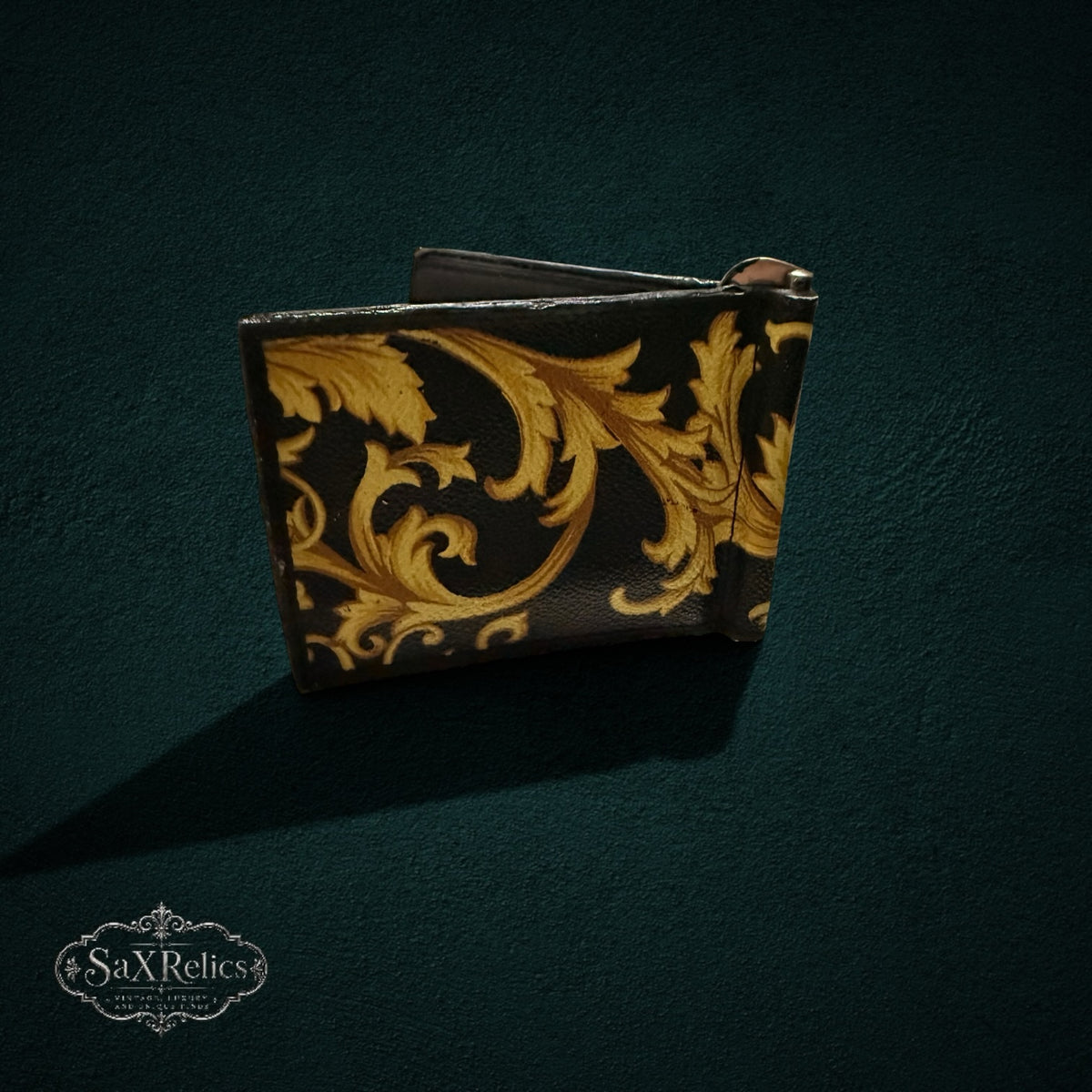 My Store Versace leather money clip wallet featuring a black and gold baroque print on a dark textured background