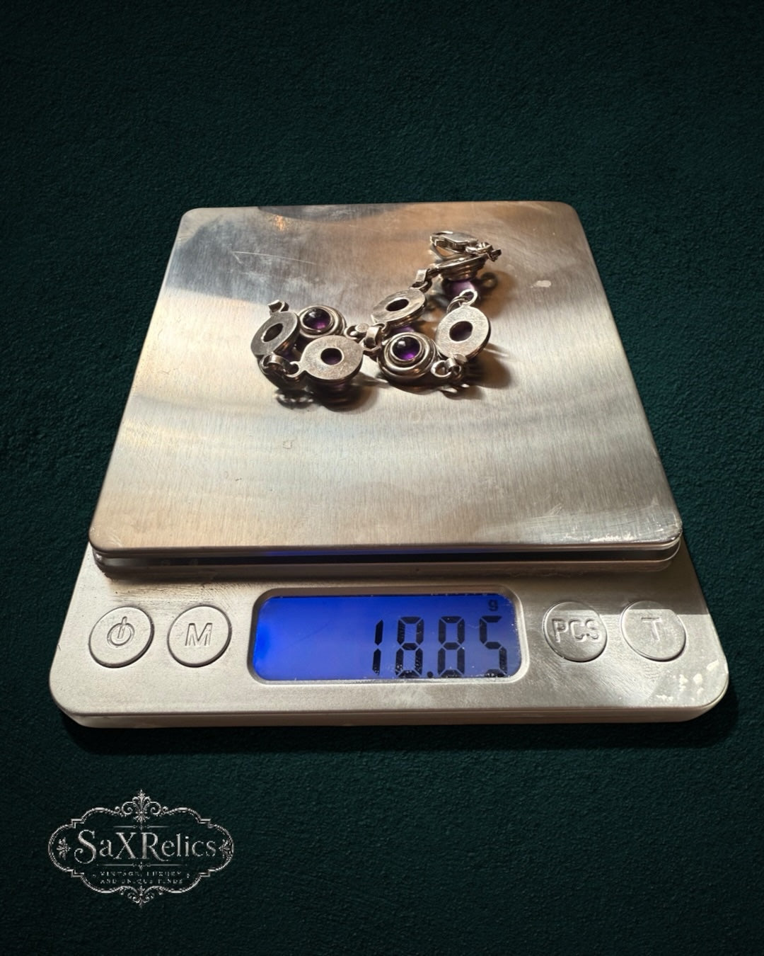 My Store SAXRelics vintage sterling silver link bracelet with purple amethyst cabochons on a digital scale