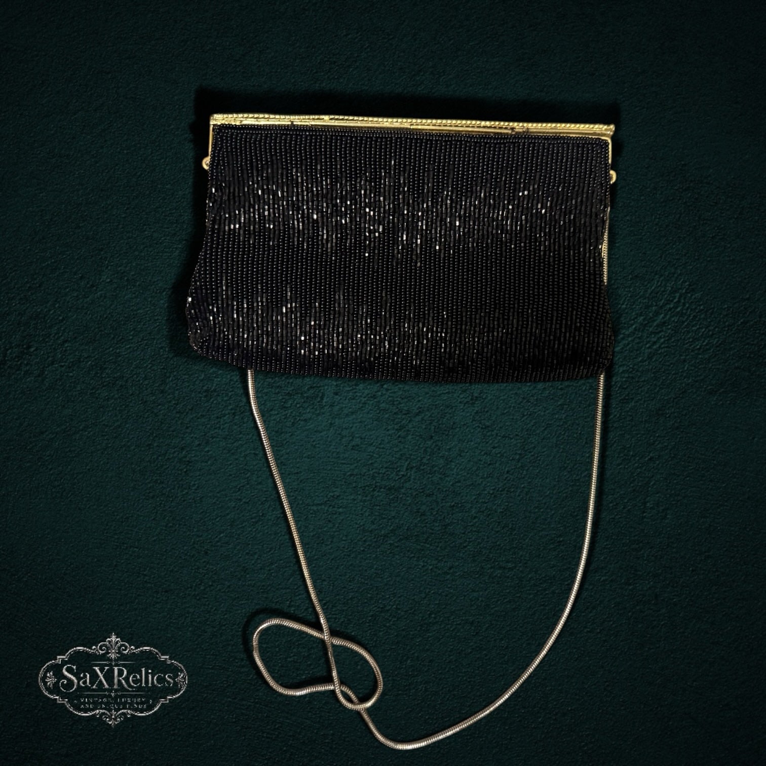 My Store vintage black beaded evening clutch with a gold-tone frame and delicate chain strap on a dark background.