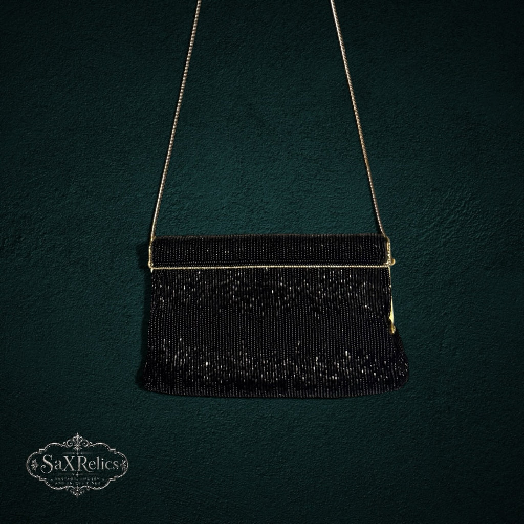 My Store vintage black beaded evening clutch with gold-tone chain strap against a dark textured background