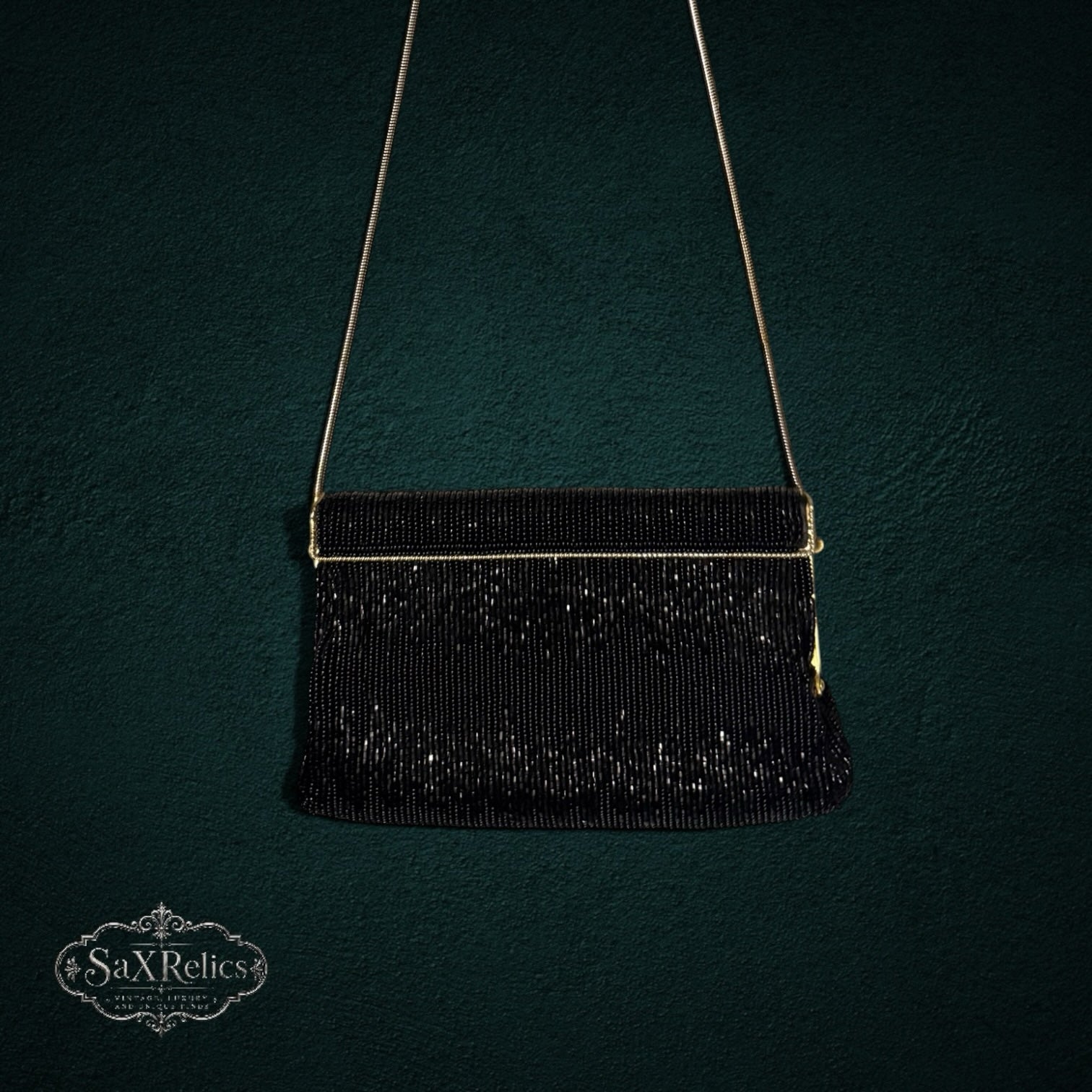 My Store vintage black beaded evening clutch with gold-tone chain strap against a dark textured background