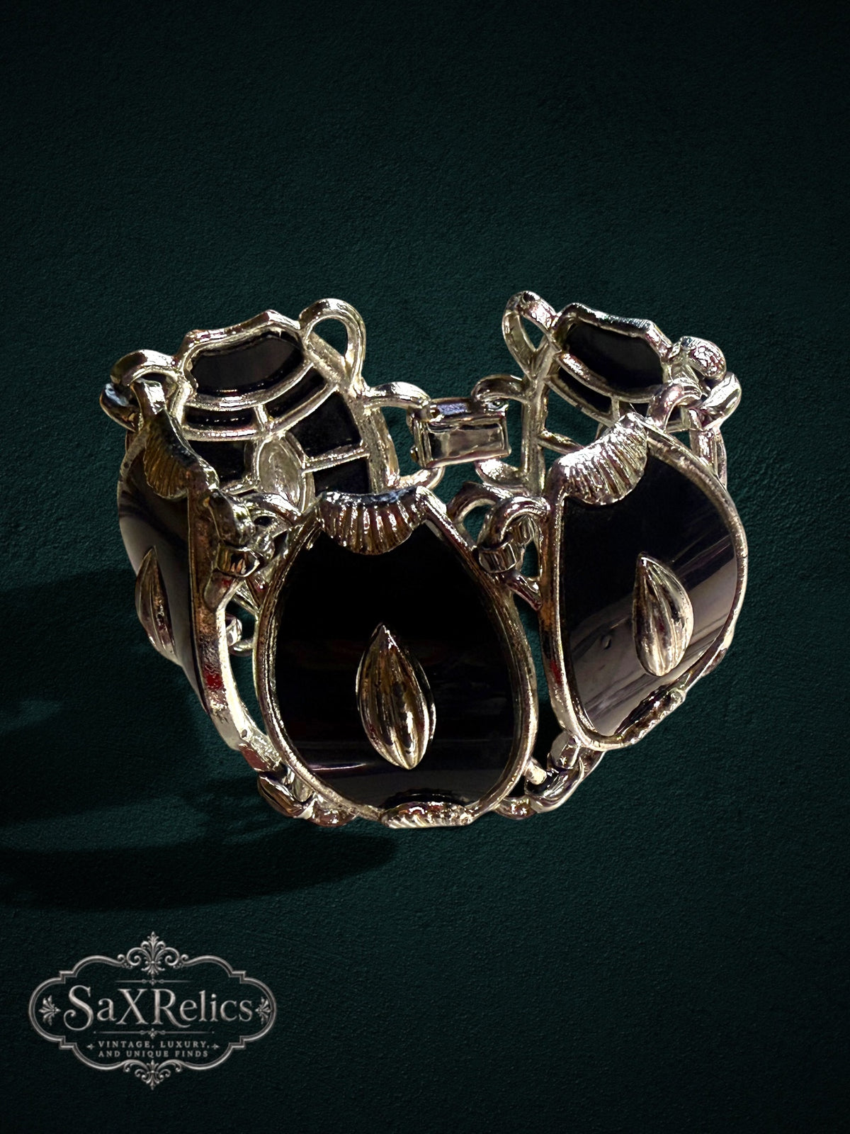 Vintage statement link bracelet with black enamel panels and polished silver-tone architectural metal frames.