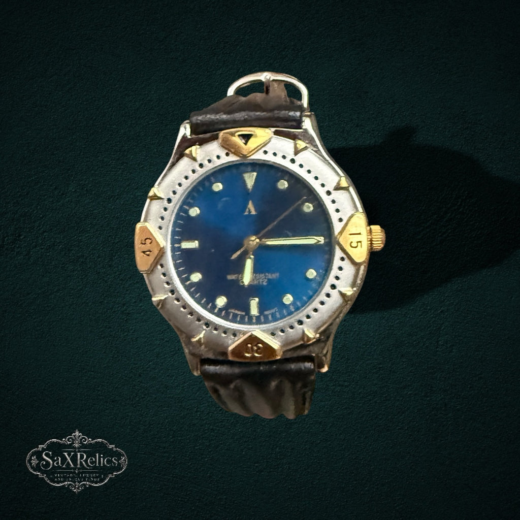 My Store vintage analog watch with a deep blue dial, two-tone silver and gold bezel, and dark brown leather strap.