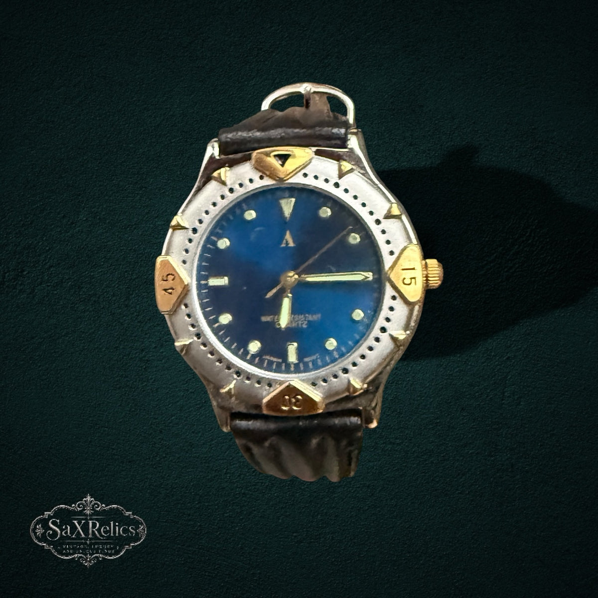My Store vintage analog watch with a deep blue dial, two-tone silver and gold bezel, and dark brown leather strap.