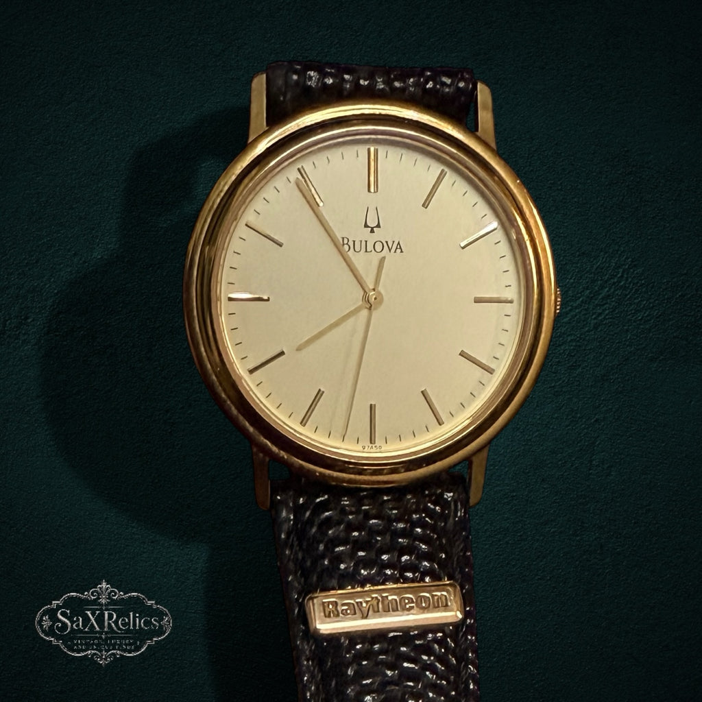 SaX Relics vintage Bulova watch with a cream dial and gold-tone case on a Raytheon plaque strap