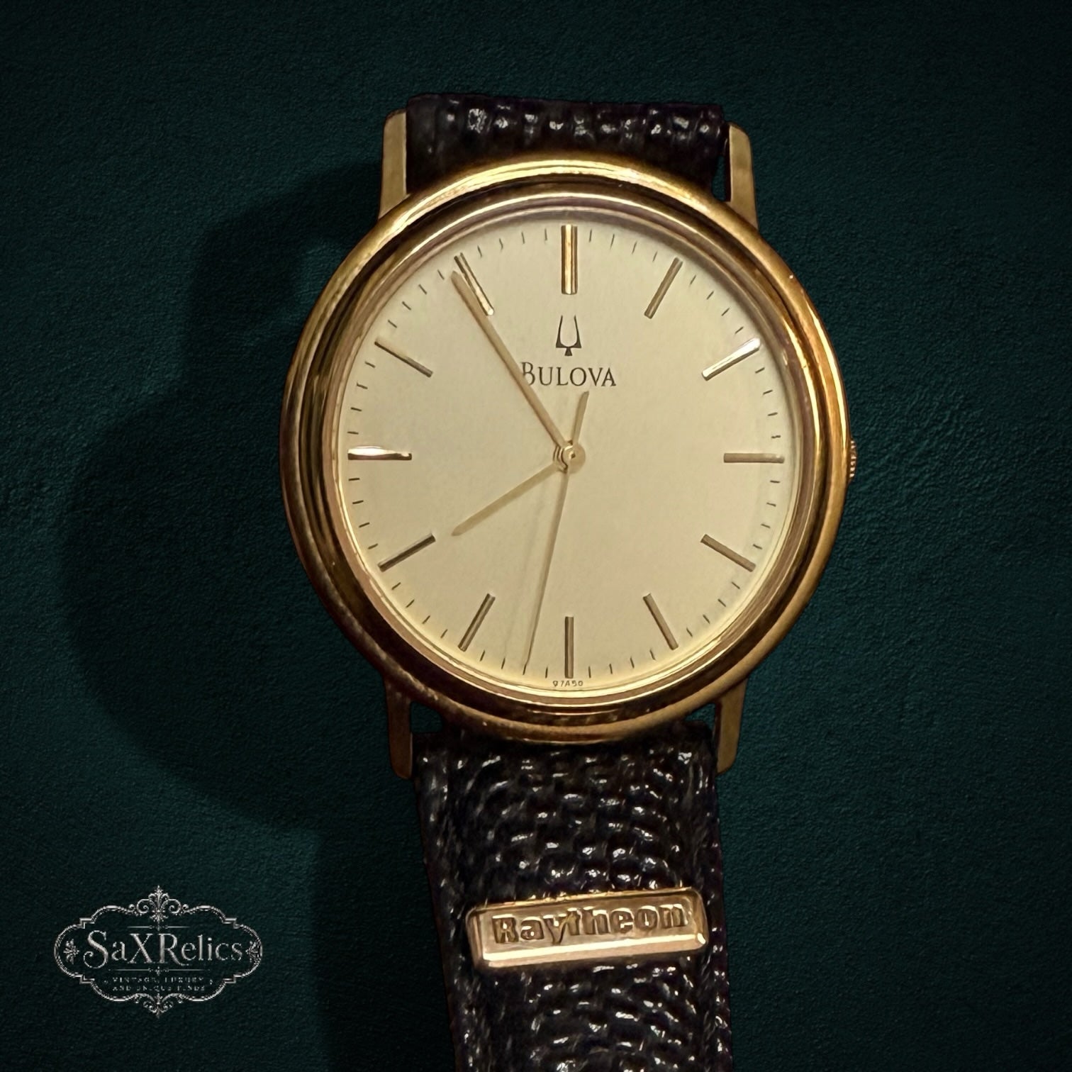 SaX Relics vintage Bulova watch with a cream dial and gold-tone case on a Raytheon plaque strap