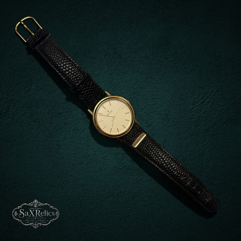 SaX Relics vintage Bulova quartz watch with a gold-tone case and black leather Raytheon presentation strap
