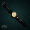 SaX Relics vintage Bulova quartz watch with a gold-tone case and black leather Raytheon presentation strap