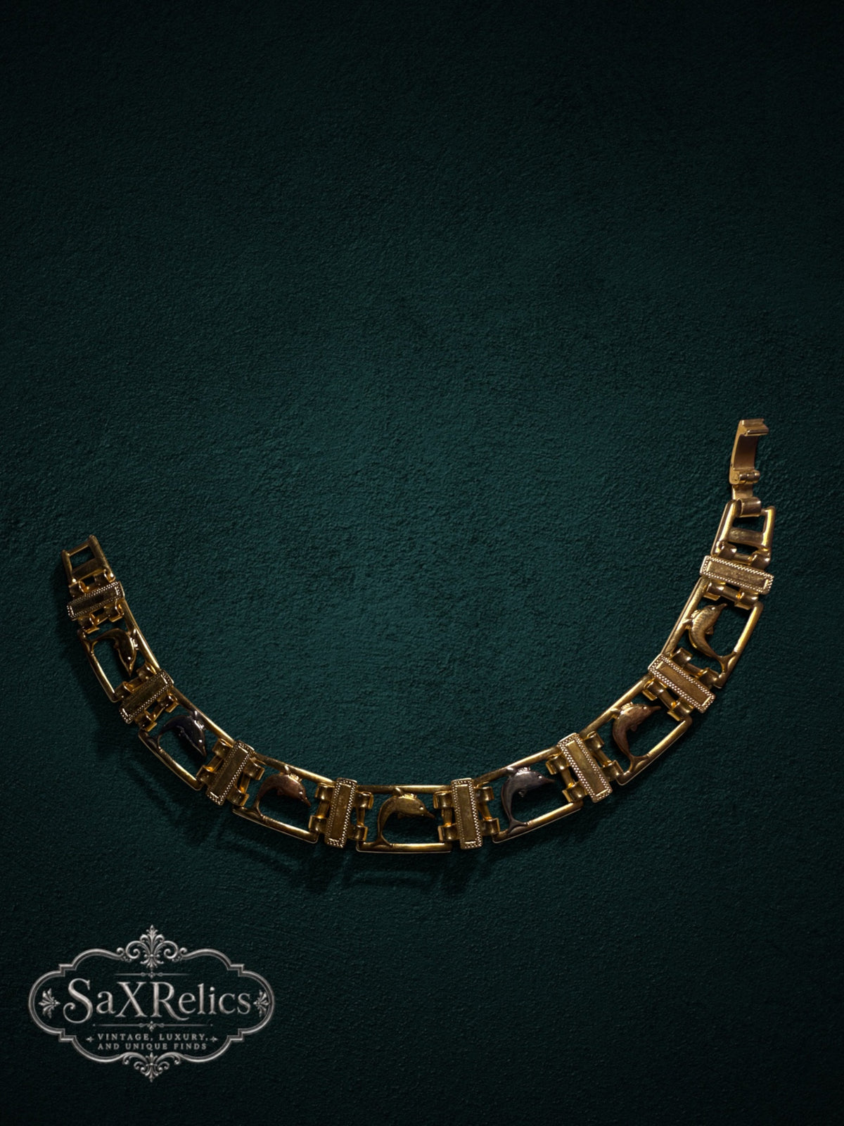 My Store vintage gold-tone link bracelet featuring articulated rectangular frames with leaping dolphin motifs.