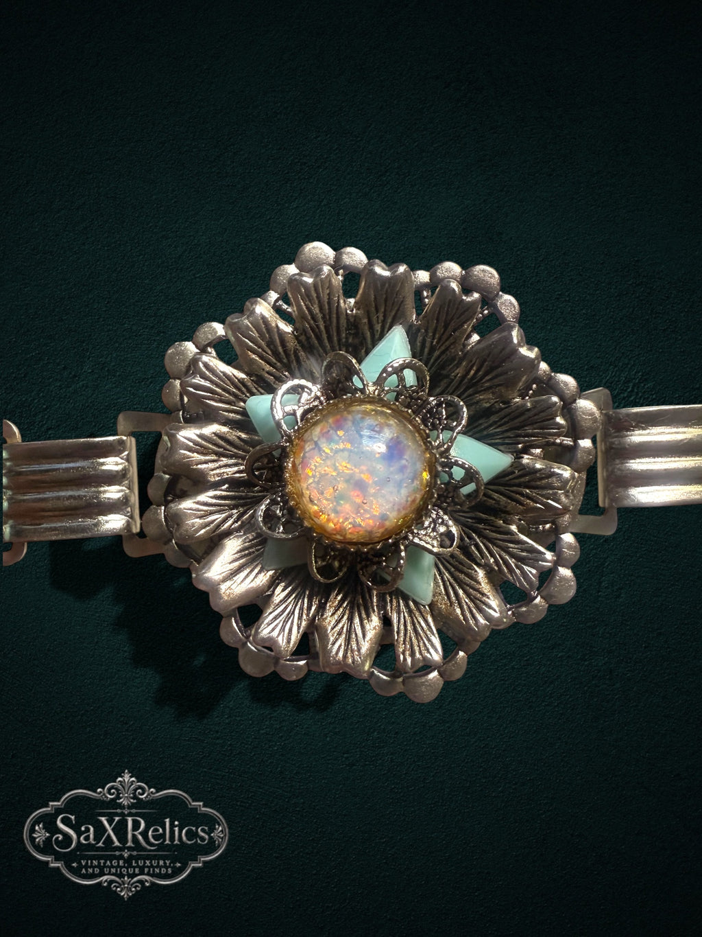 Vintage ornate floral link bracelet with iridescent cabochon and seafoam green accents in silver-tone metal
