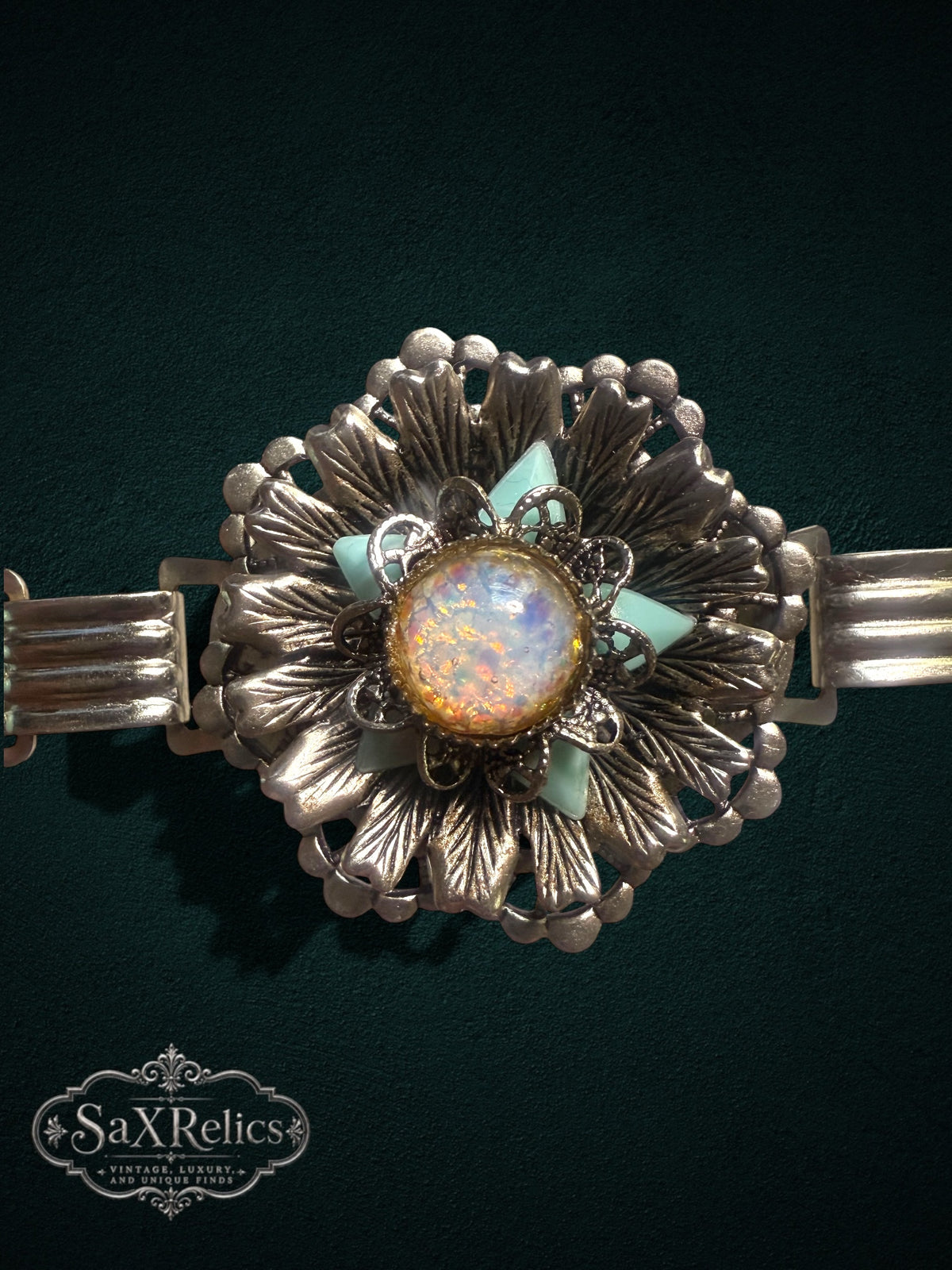 Vintage ornate floral link bracelet with iridescent cabochon and seafoam green accents in silver-tone metal