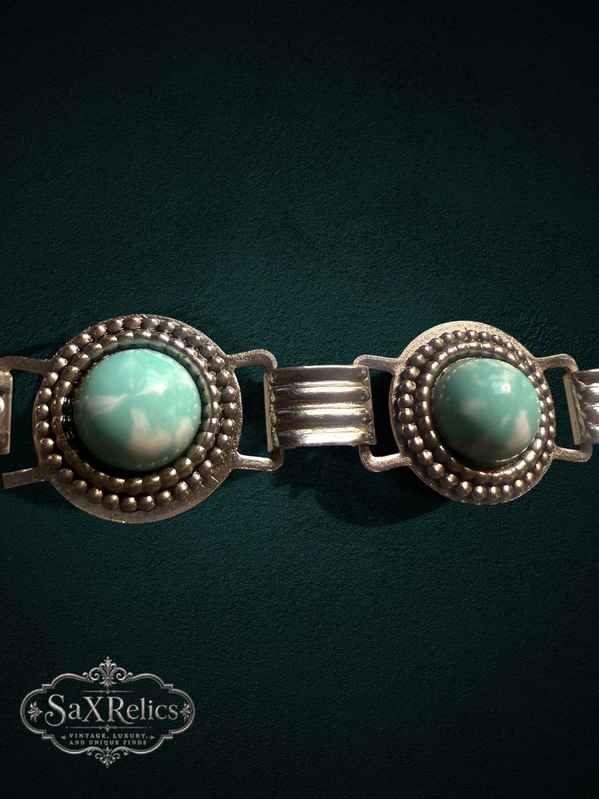 Vintage ornate silver-tone link bracelet with seafoam-green cabochons and intricate beaded metal detailing.