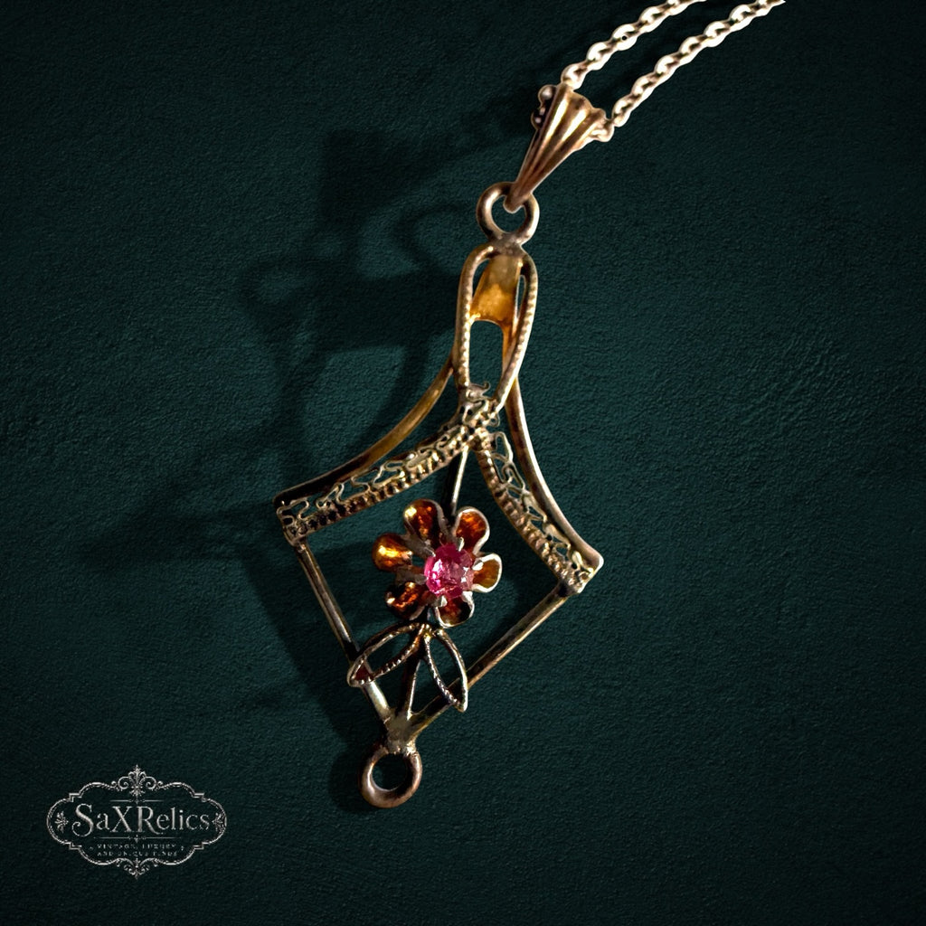 SaX Relics — Pétalo vintage 12K gold fill pendant, diamond-shaped frame around a floral motif with a pink stone.