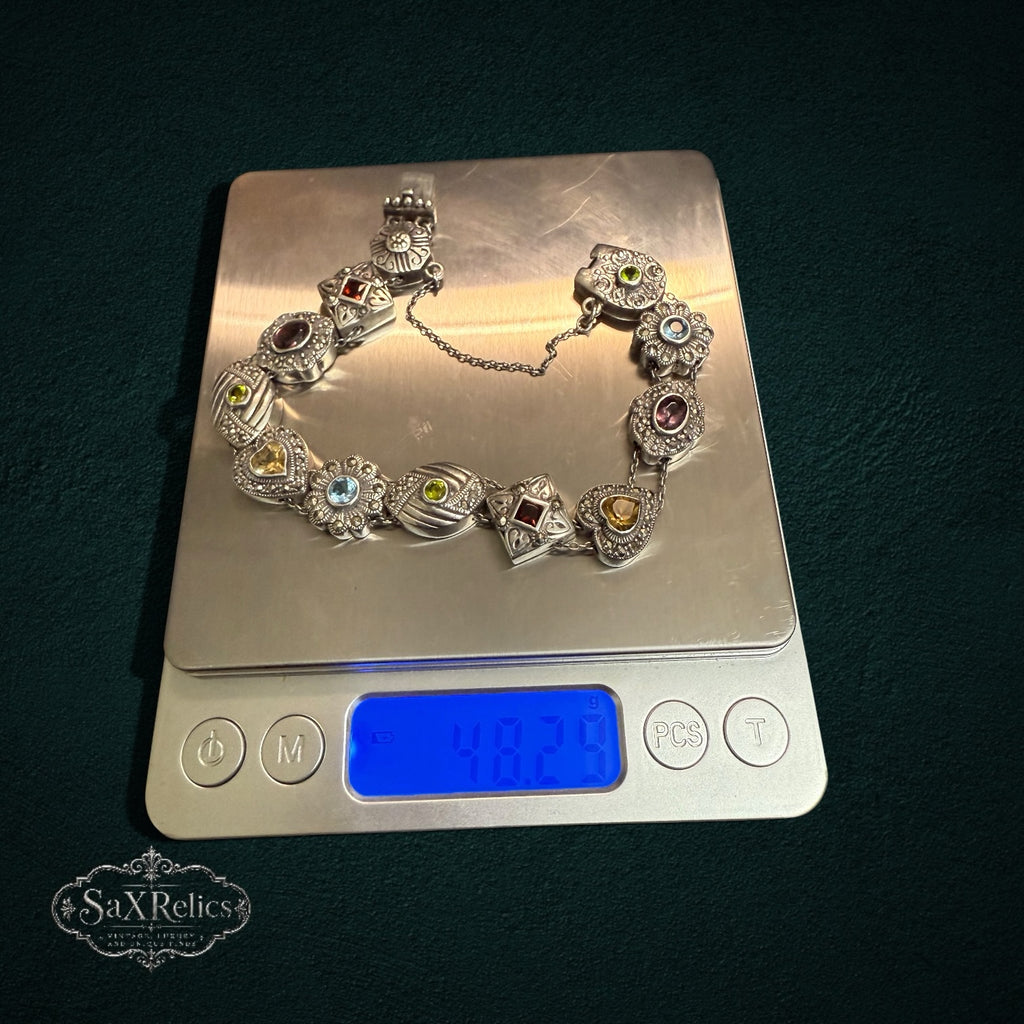 SaX Relics vintage sterling silver multi-stone link bracelet on a digital scale reading 48.29 grams