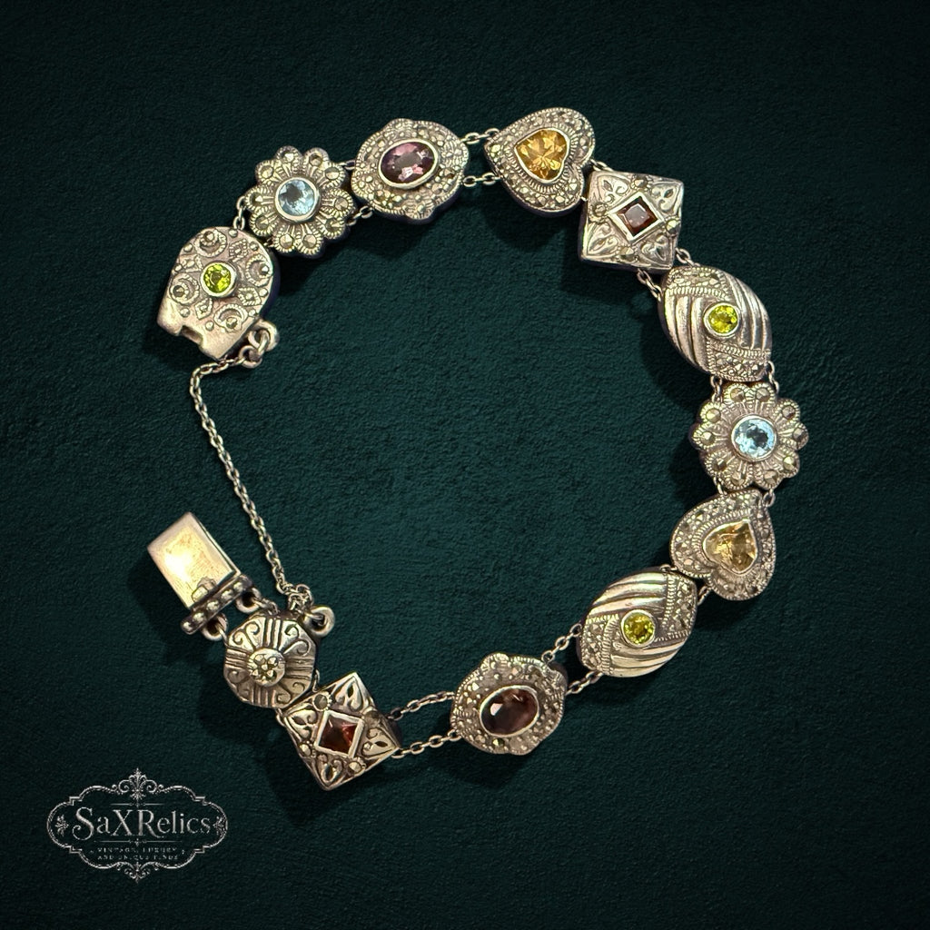 SaX Relics vintage sterling silver bracelet showing textured link motifs and multi-color faceted stones