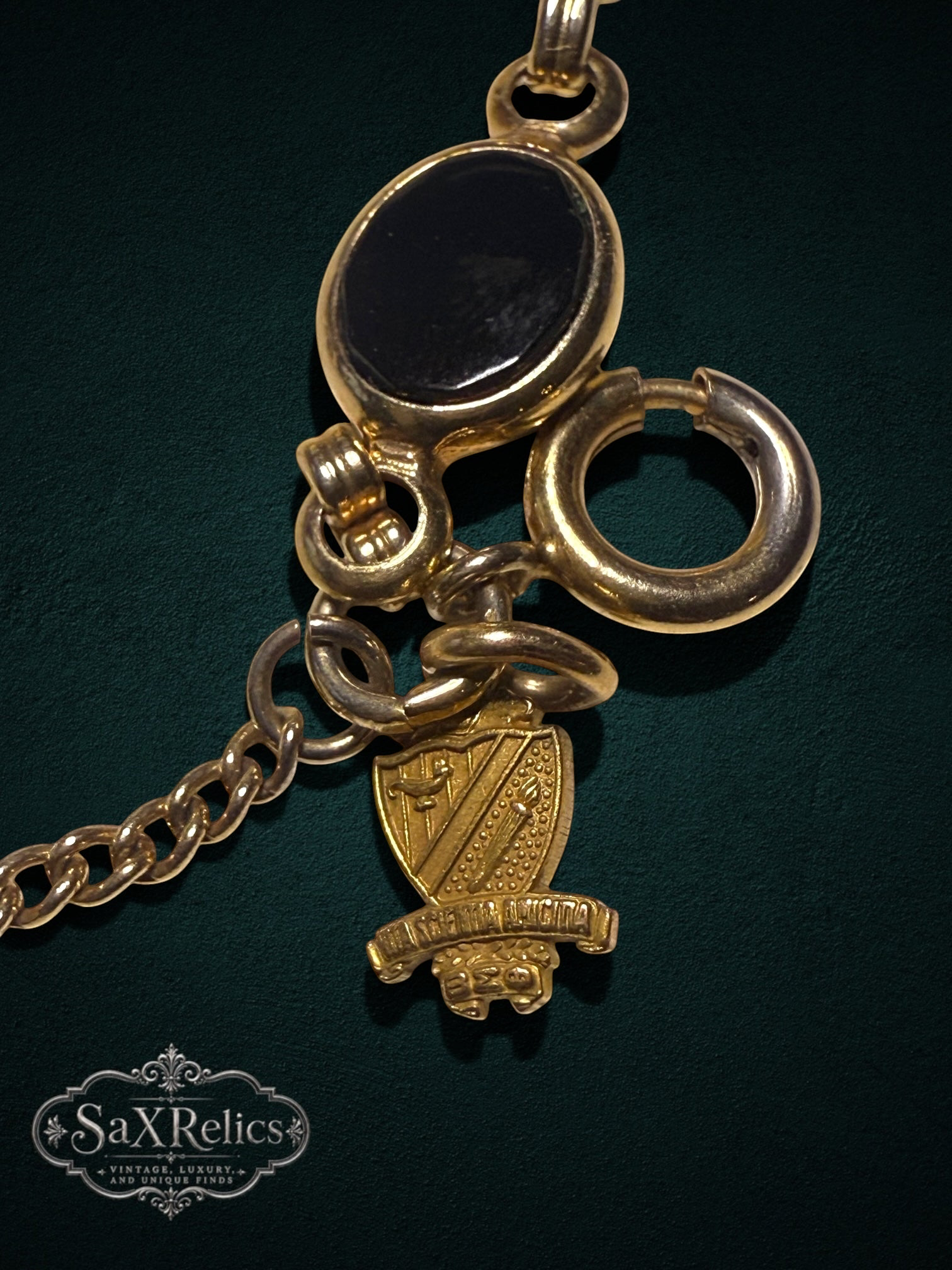 My Store vintage gold-tone bracelet featuring oval black cabochon links and an intricate heraldic crest charm