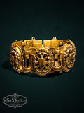 Ornate vintage-style gold-tone link bracelet featuring intricate filigree and scrollwork patterns.