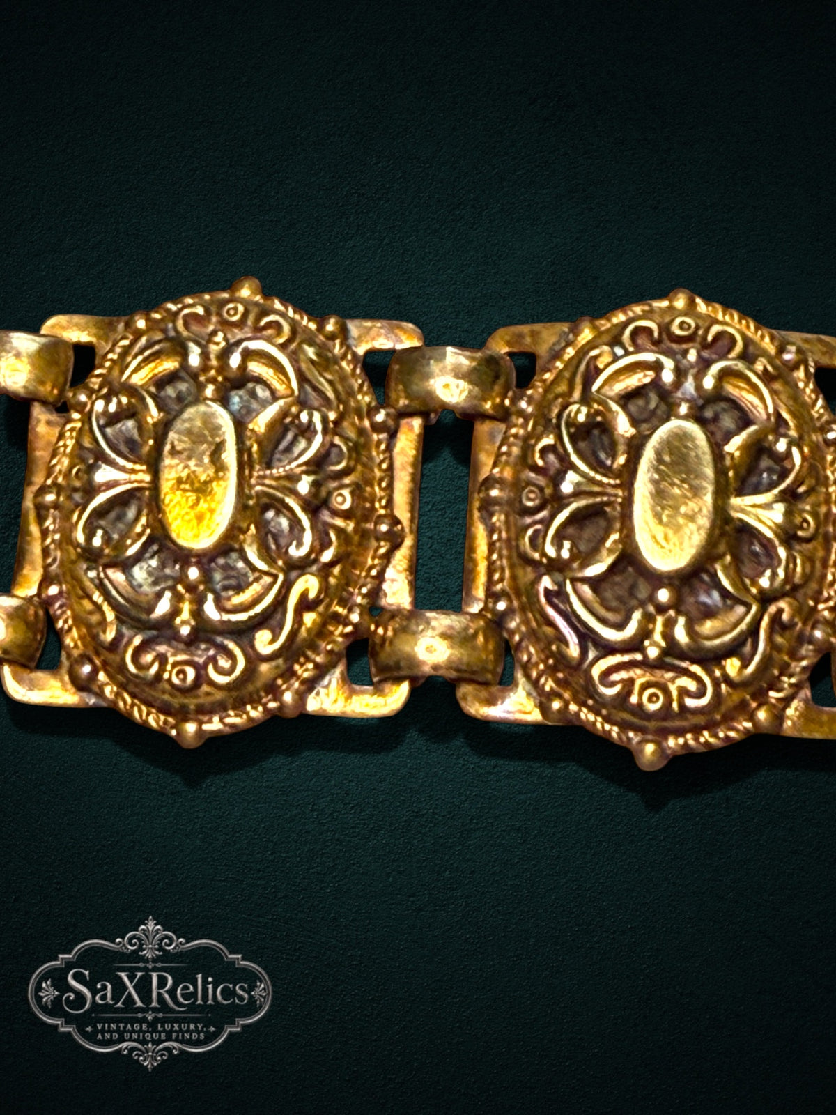 Ornate vintage-style gold-tone link bracelet featuring intricate filigree and scrollwork patterns.