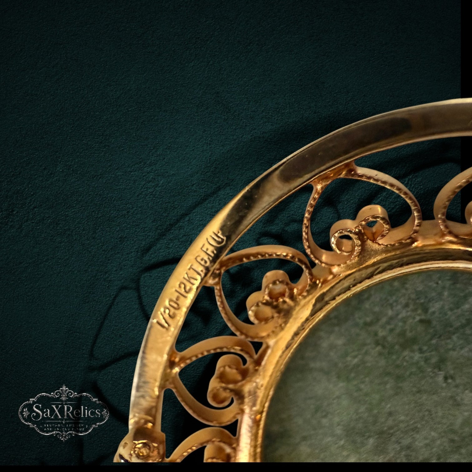 My Store vintage 12k gold-filled filigree pendant and brooch frame with hallmark detail on a dark green background.