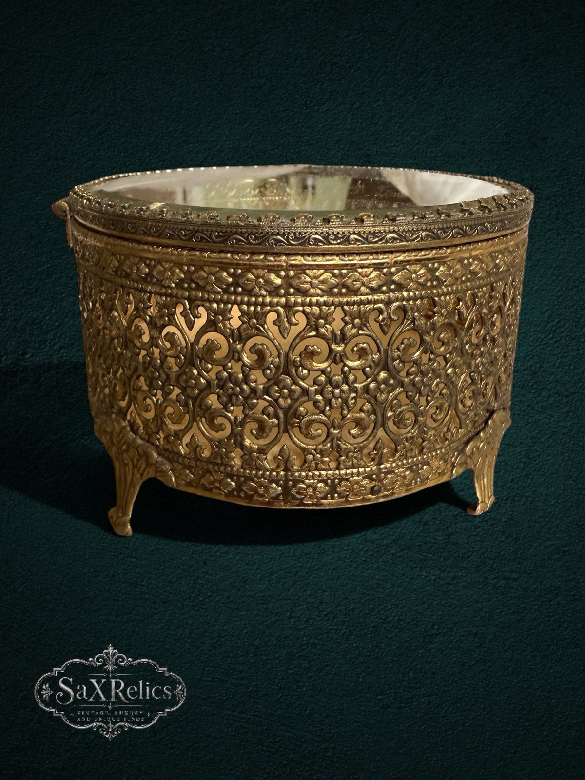My Store ornate vintage gold-tone metal trinket box with intricate filigree scrollwork and floral motifs on curved feet