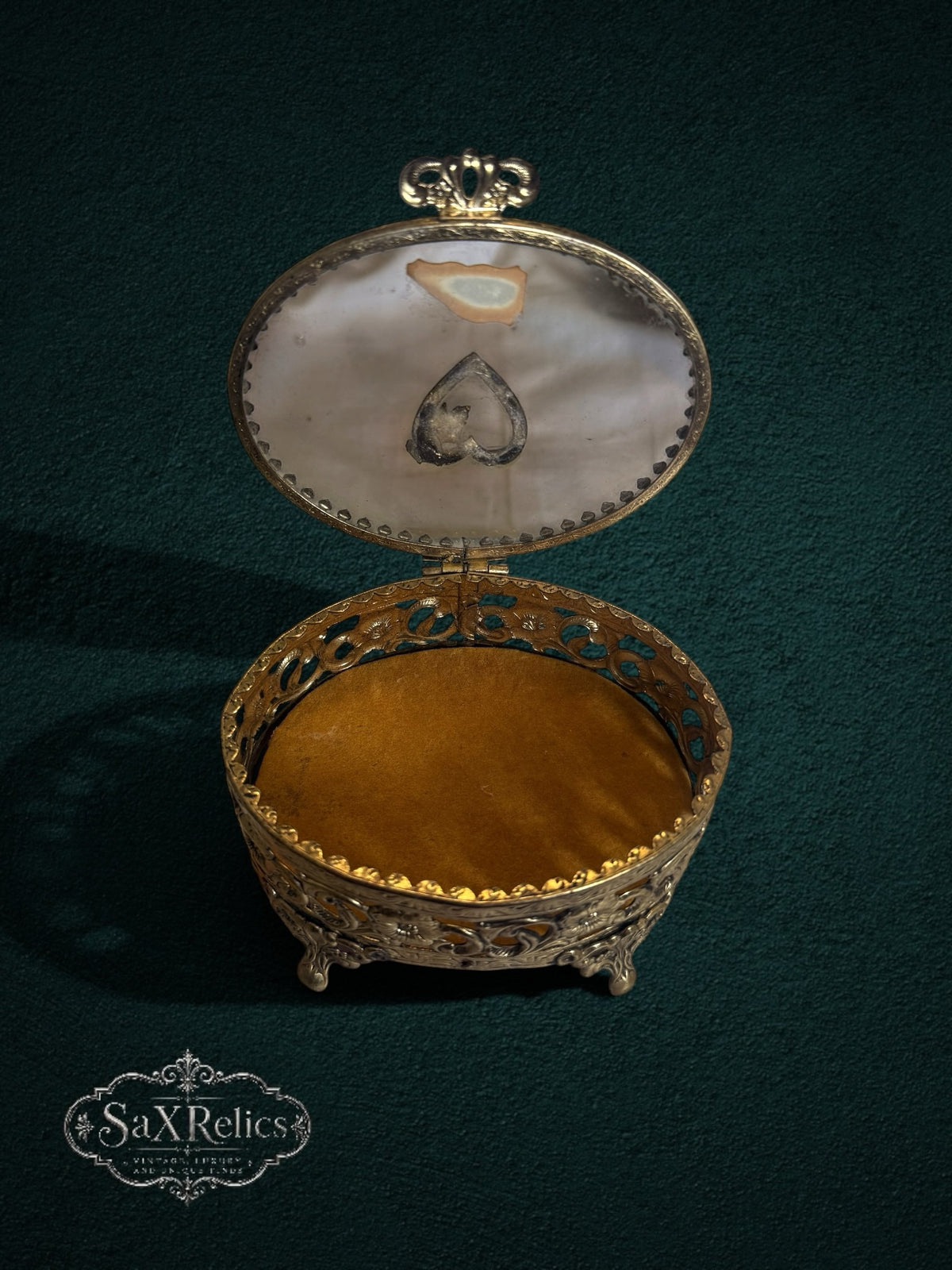 My Store vintage-style oval gold metal jewelry box with intricate floral filigree, glass lid, and velvet interior.