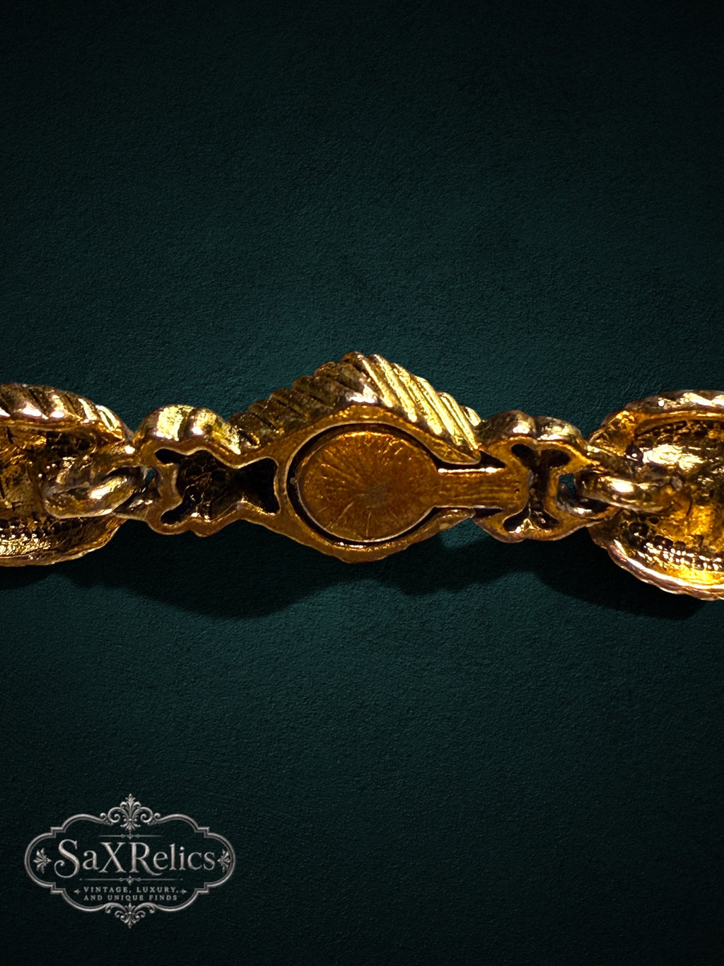 Vintage ornate gold-tone link bracelet with intricate textured metalwork and a secure integrated clasp.