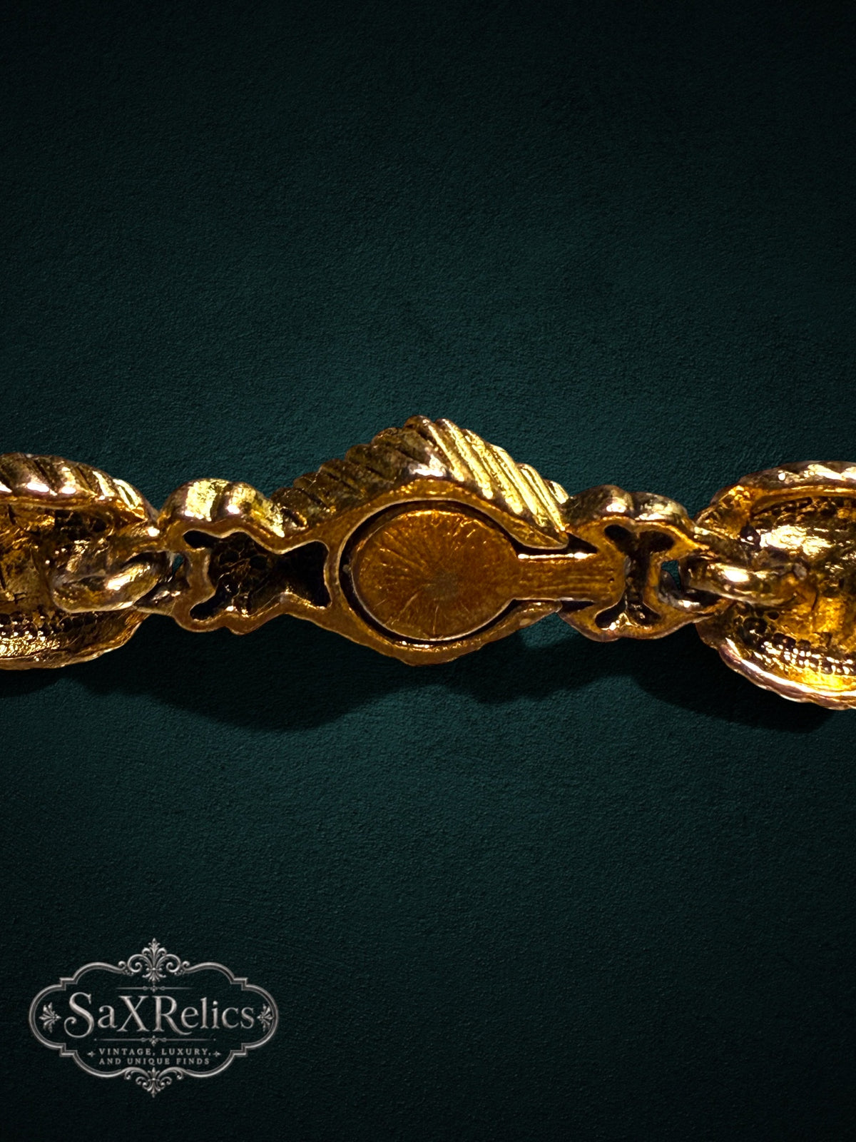 Vintage ornate gold-tone link bracelet with intricate textured metalwork and a secure integrated clasp.