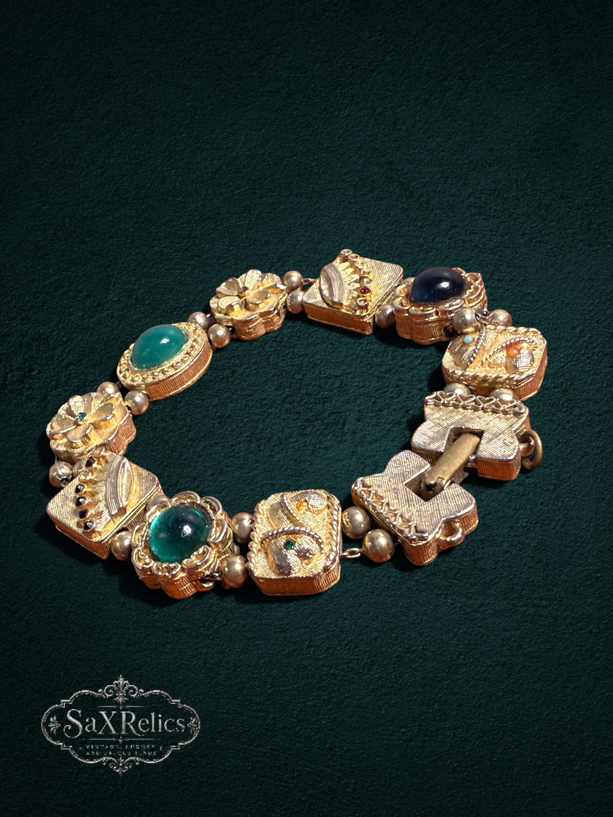 My Store vintage gold-tone link bracelet with emerald green and midnight blue cabochon stones and floral motifs.