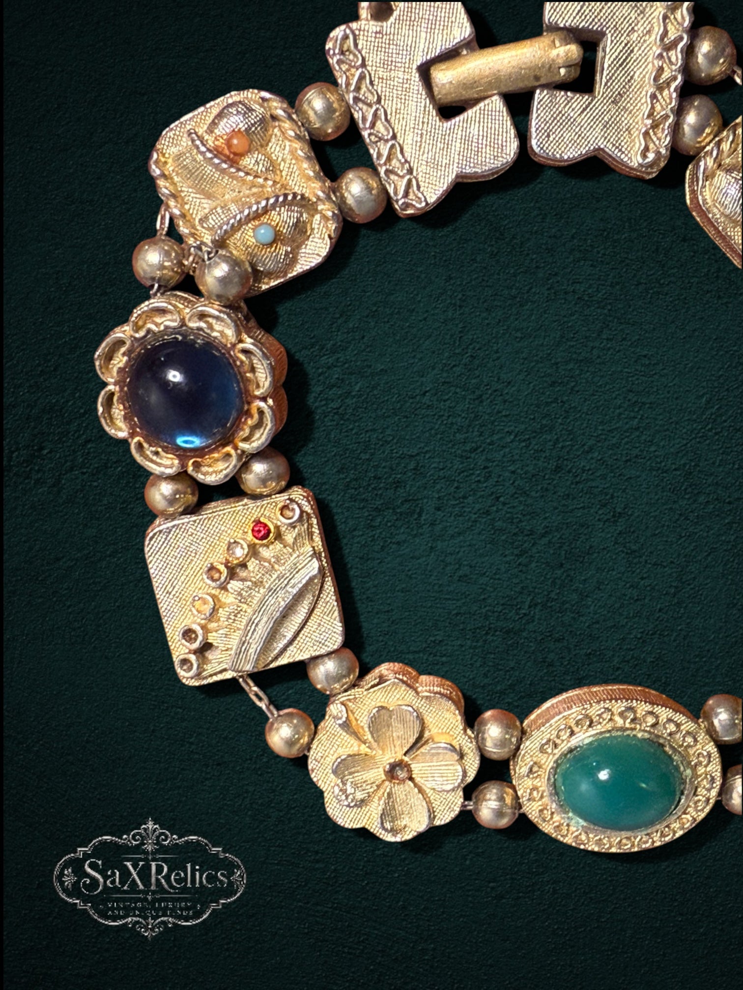 My Store vintage gold-tone link bracelet featuring ornate geometric squares, floral motifs, and emerald and blue stones.