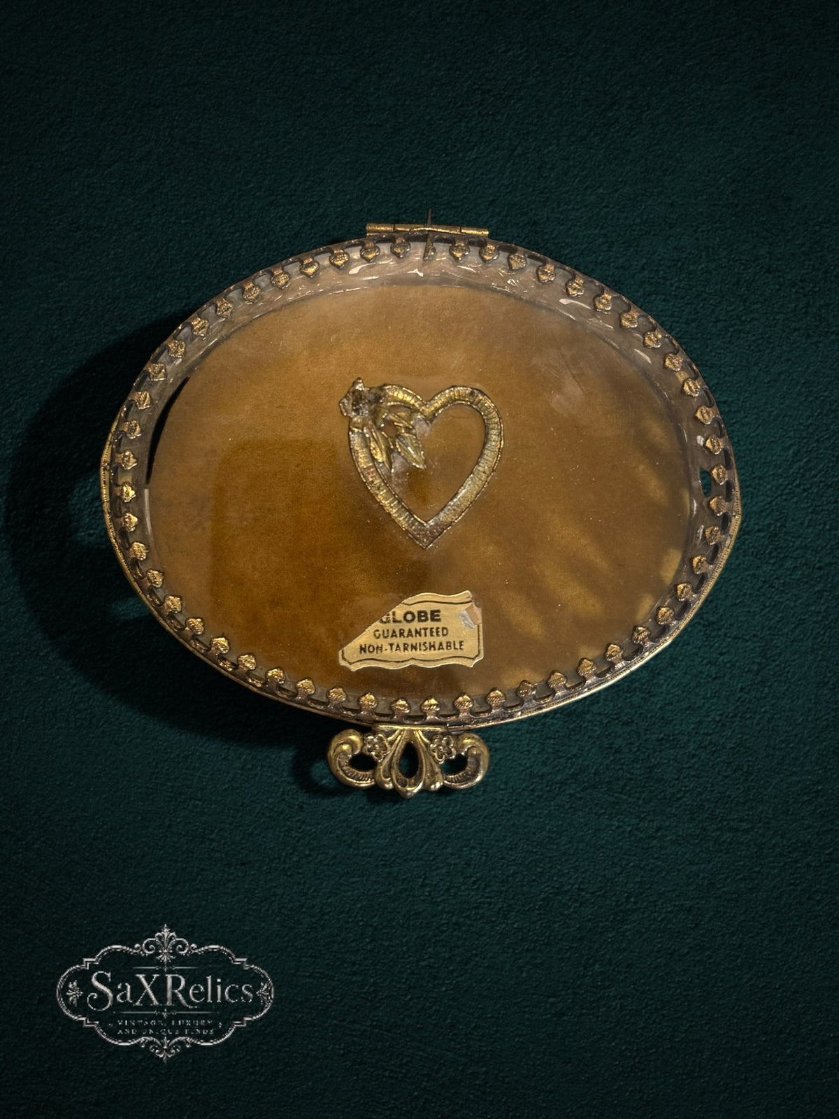 My Store vintage oval gold-tone metal trinket box with heart emblem, glass lid, and ornate filigree detail.