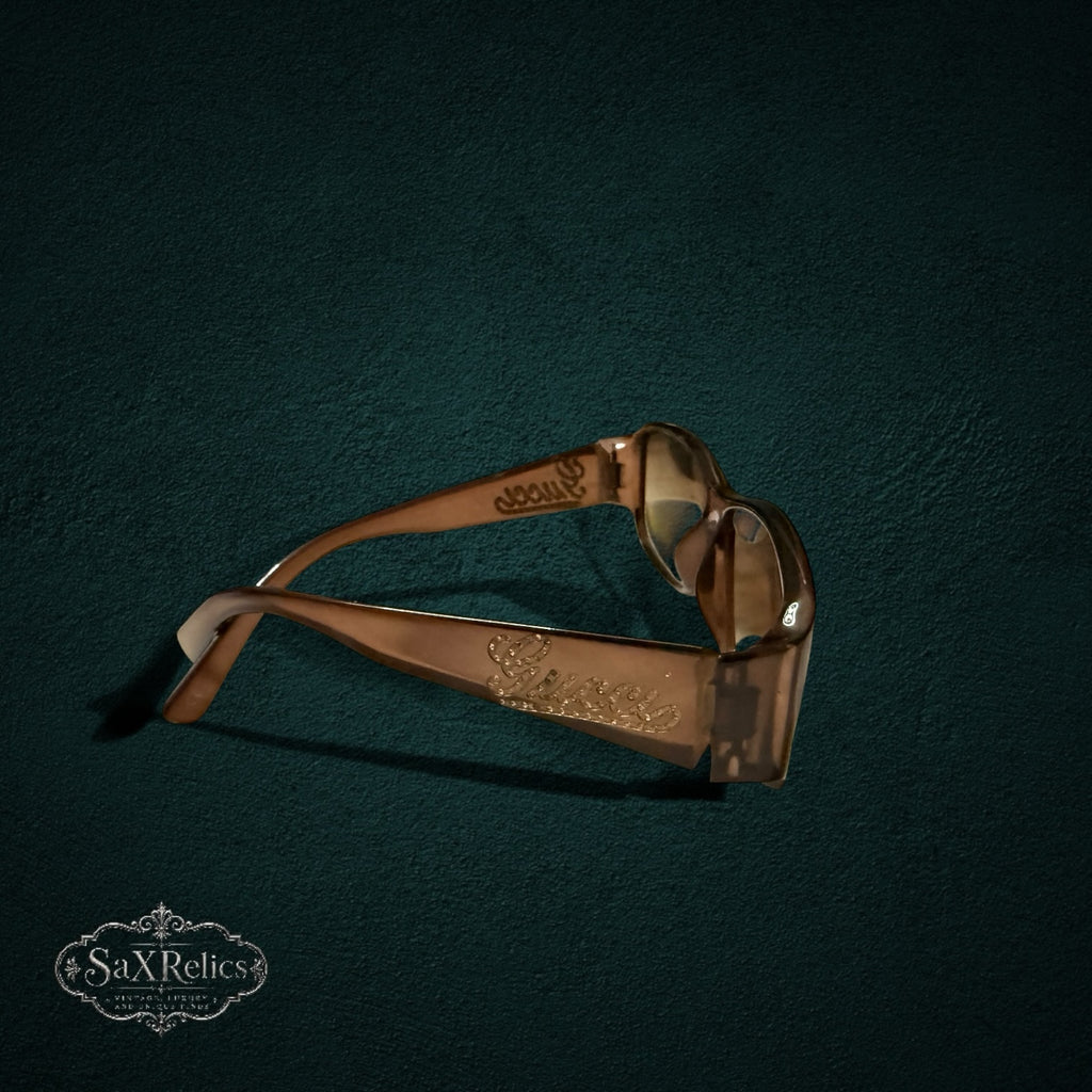 My Store vintage brown Gucci sunglasses in Optyl featuring crystal-embellished logo temples on a dark green background.