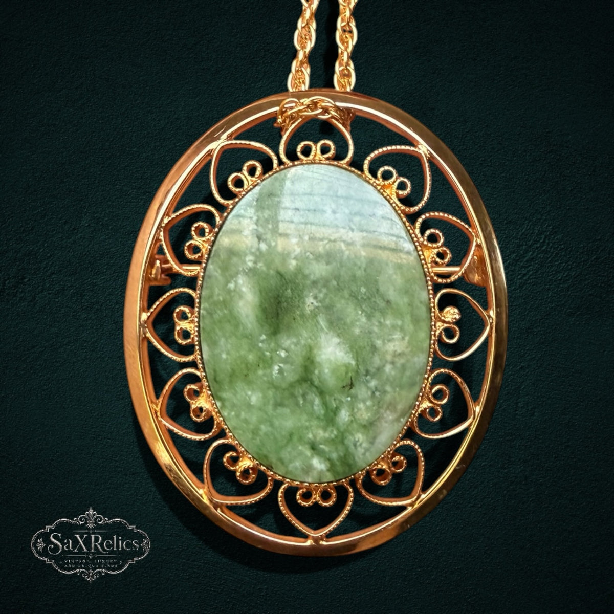 My Store vintage-inspired oval pendant brooch featuring a polished green jade stone set in intricate 12k gold-filled filigree
