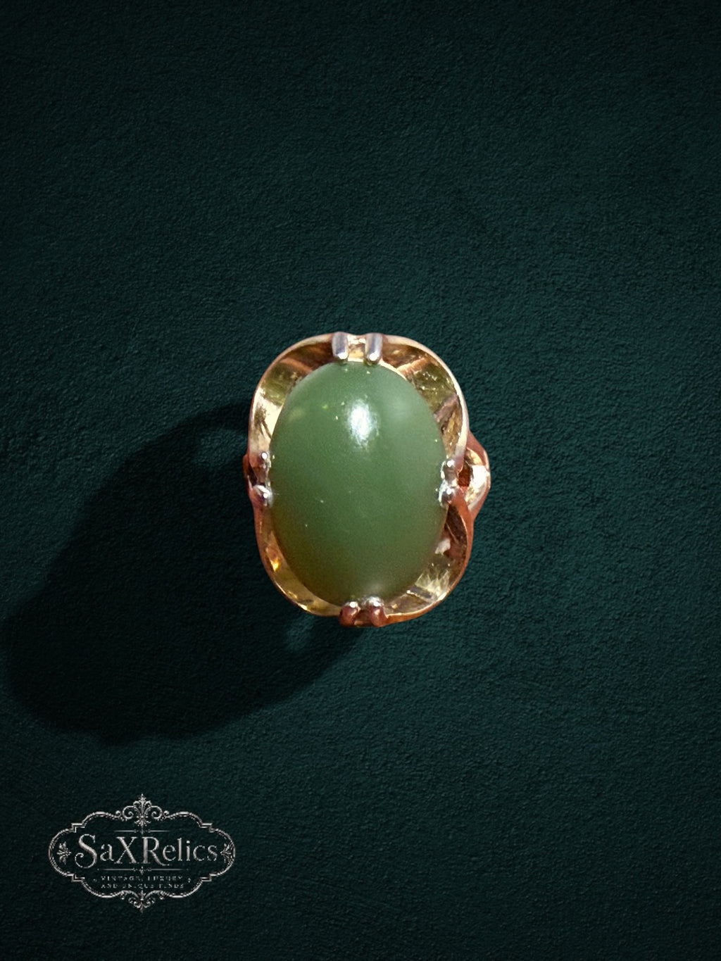My Store vintage-inspired statement ring featuring a polished oval green jade cabochon in a sculptural gold setting.