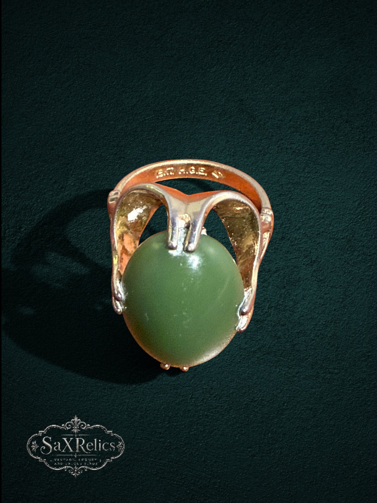 My Store vintage SaxRelics statement ring featuring an oval green jade cabochon in a sculptural gold-tone setting.