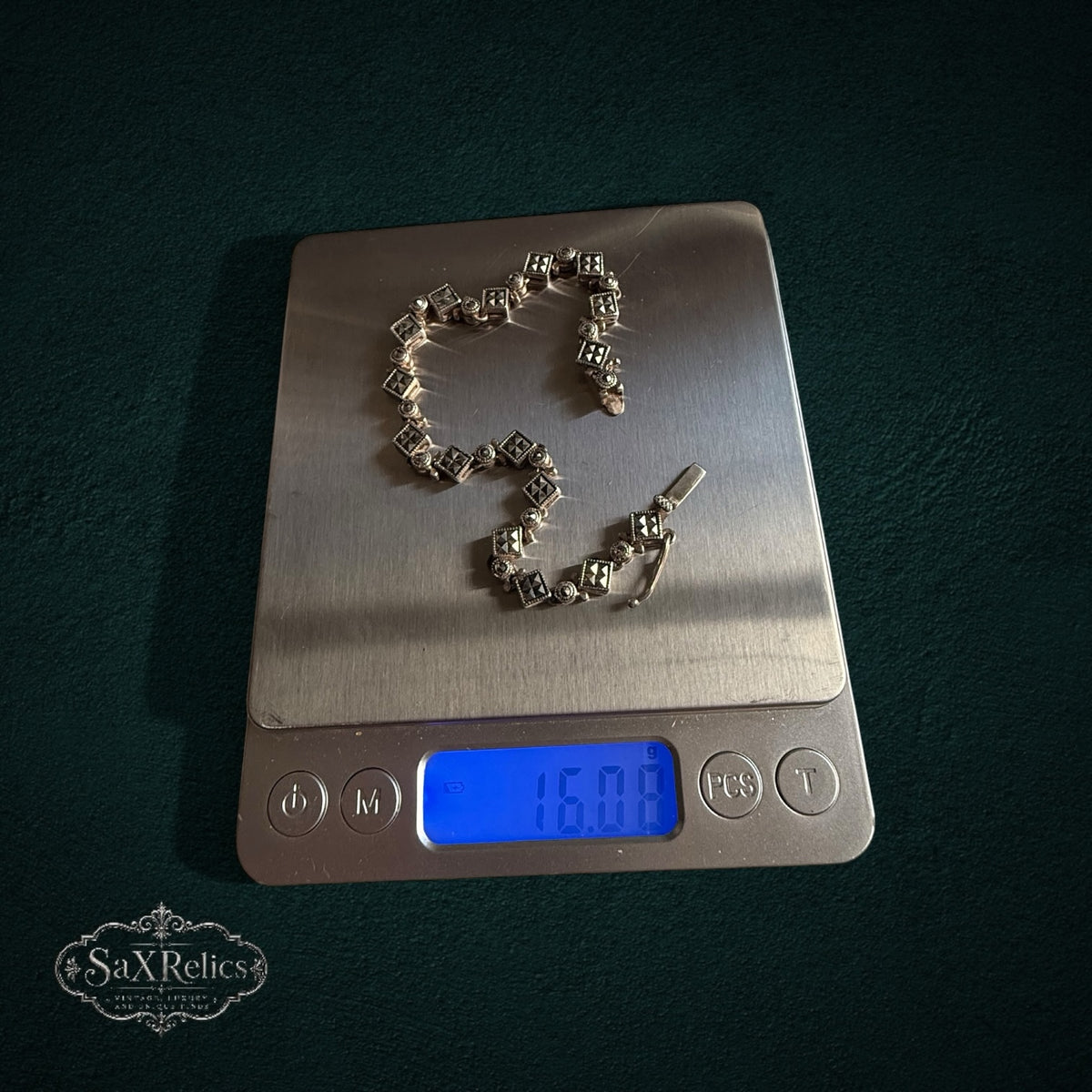 SaX Relics — Rocío sterling silver marcasite set on a digital scale at 16.08 grams.