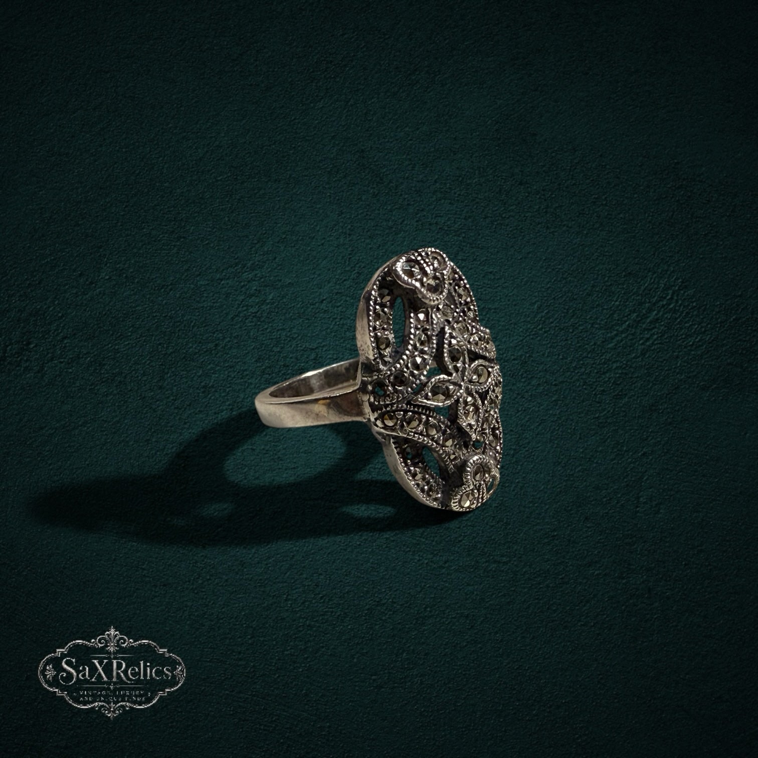 My Store vintage sterling silver ring with an elongated oval face, intricate filigree metalwork, and marcasite stones.