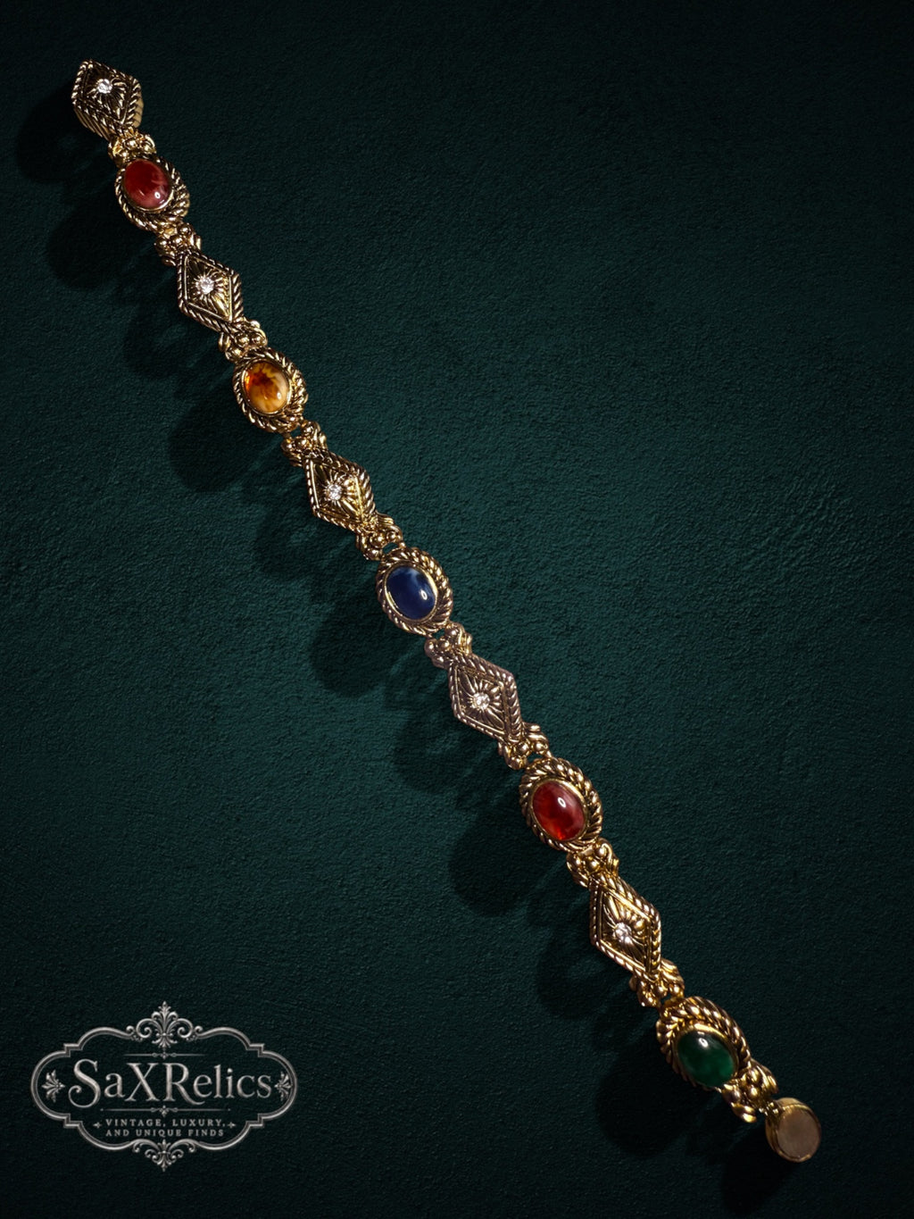 Vintage gold-tone link bracelet with multi-colored cabochon gemstones and crystal-accented diamond links.