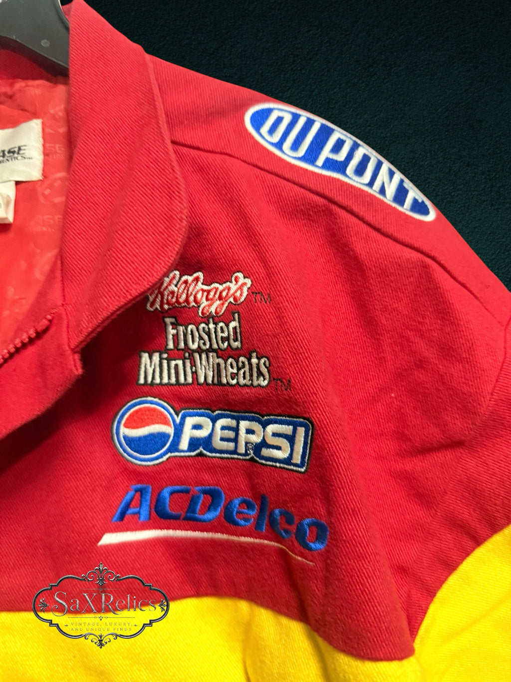 My Store vintage Chase Authentics Jeff Gordon NASCAR racing jacket with embroidered sponsor patches on red fabric.