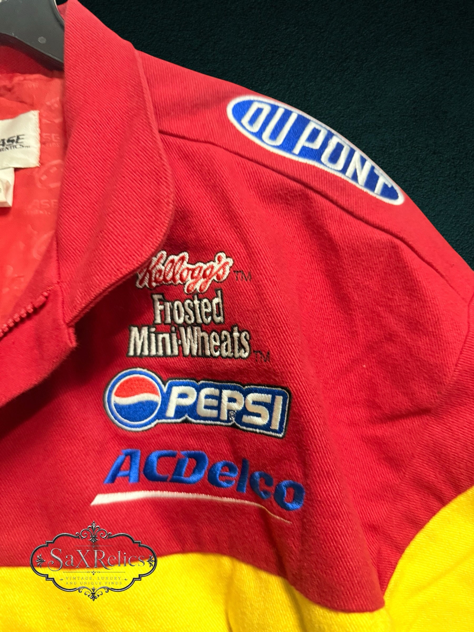 My Store vintage Chase Authentics Jeff Gordon NASCAR racing jacket with embroidered sponsor patches on red fabric.