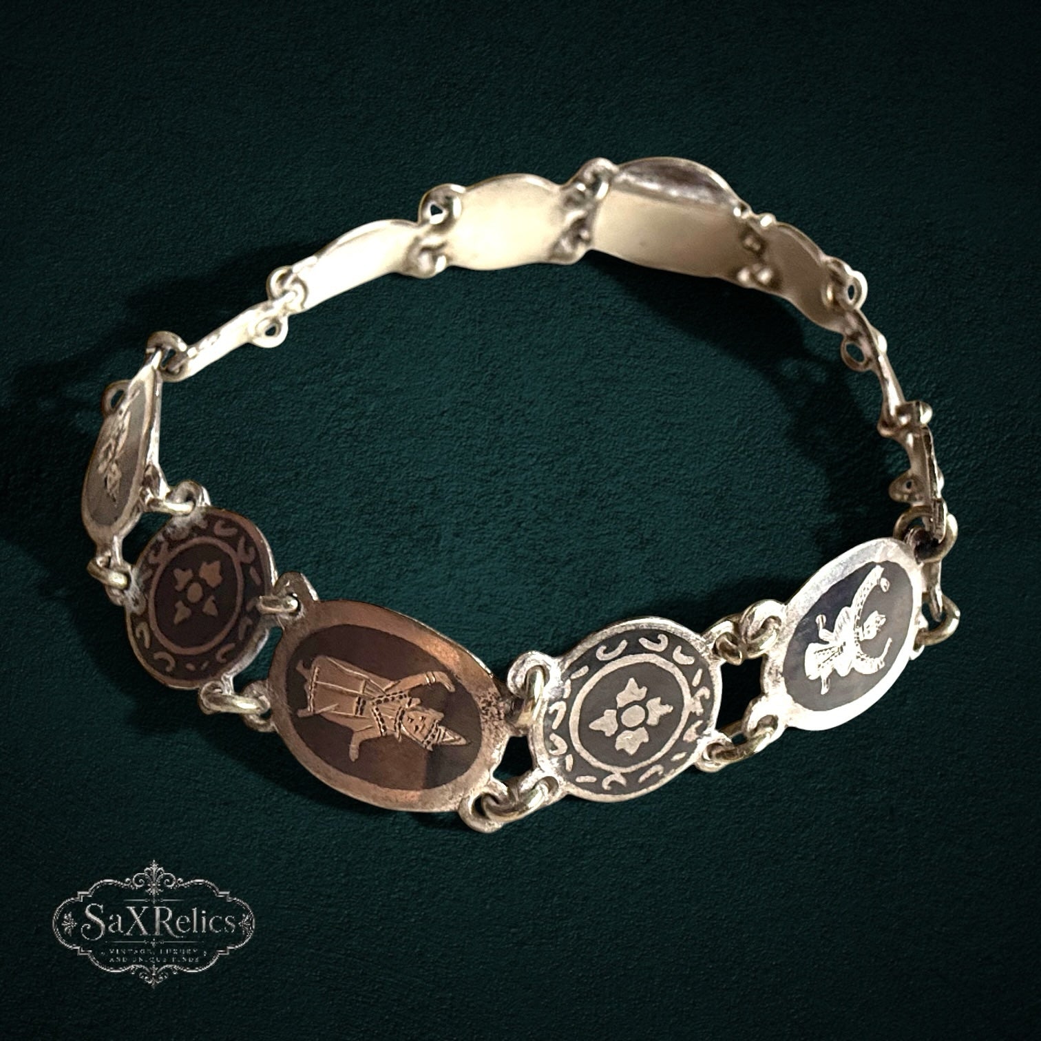 SaX Relics — Azabache vintage Siam sterling silver niello bracelet with figural and floral oval panels.