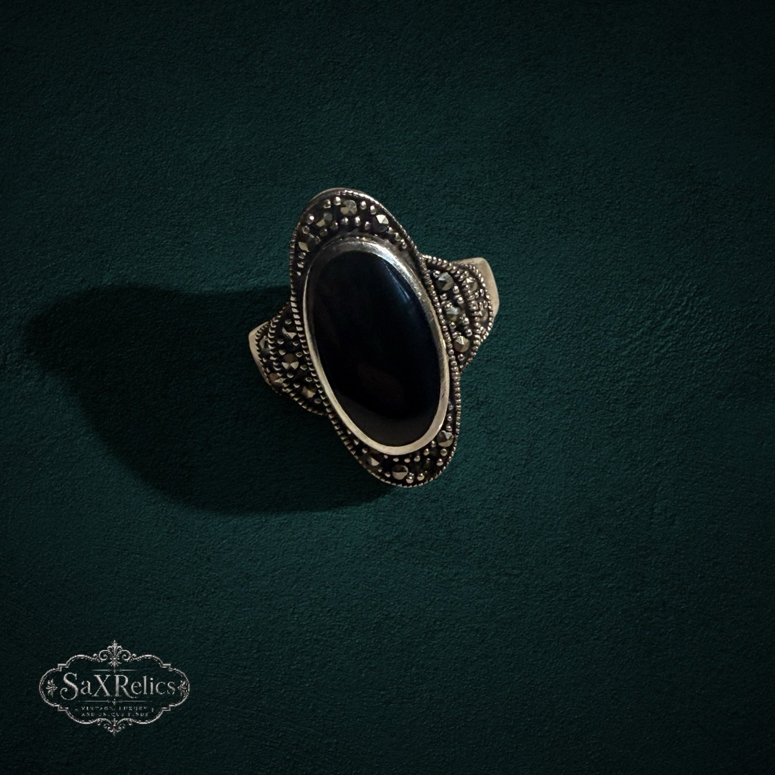 My Store vintage style sterling silver ring featuring an elongated black onyx stone and intricate marcasite detailing.