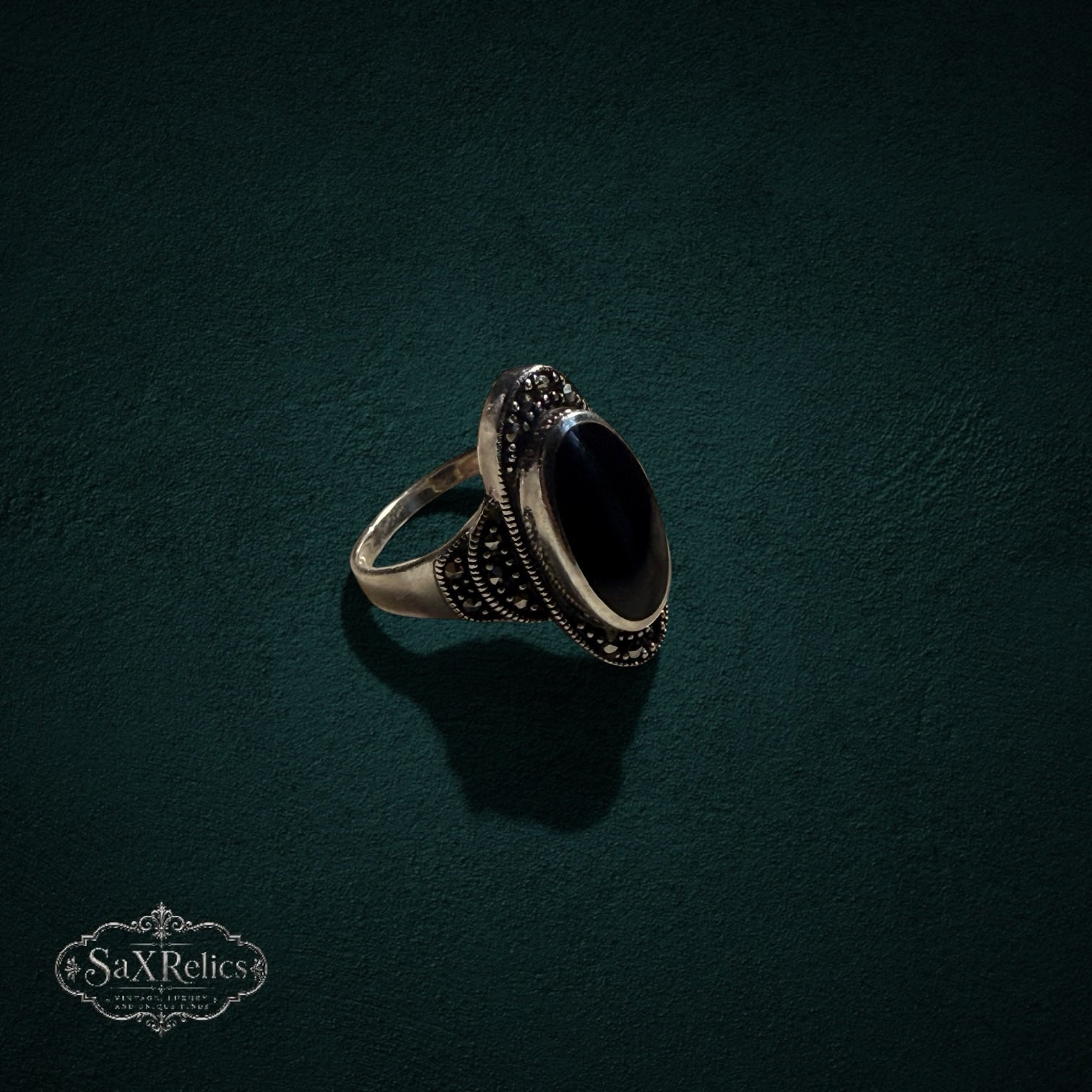 My Store vintage style sterling silver ring with an elongated black onyx stone and intricate marcasite detailing.